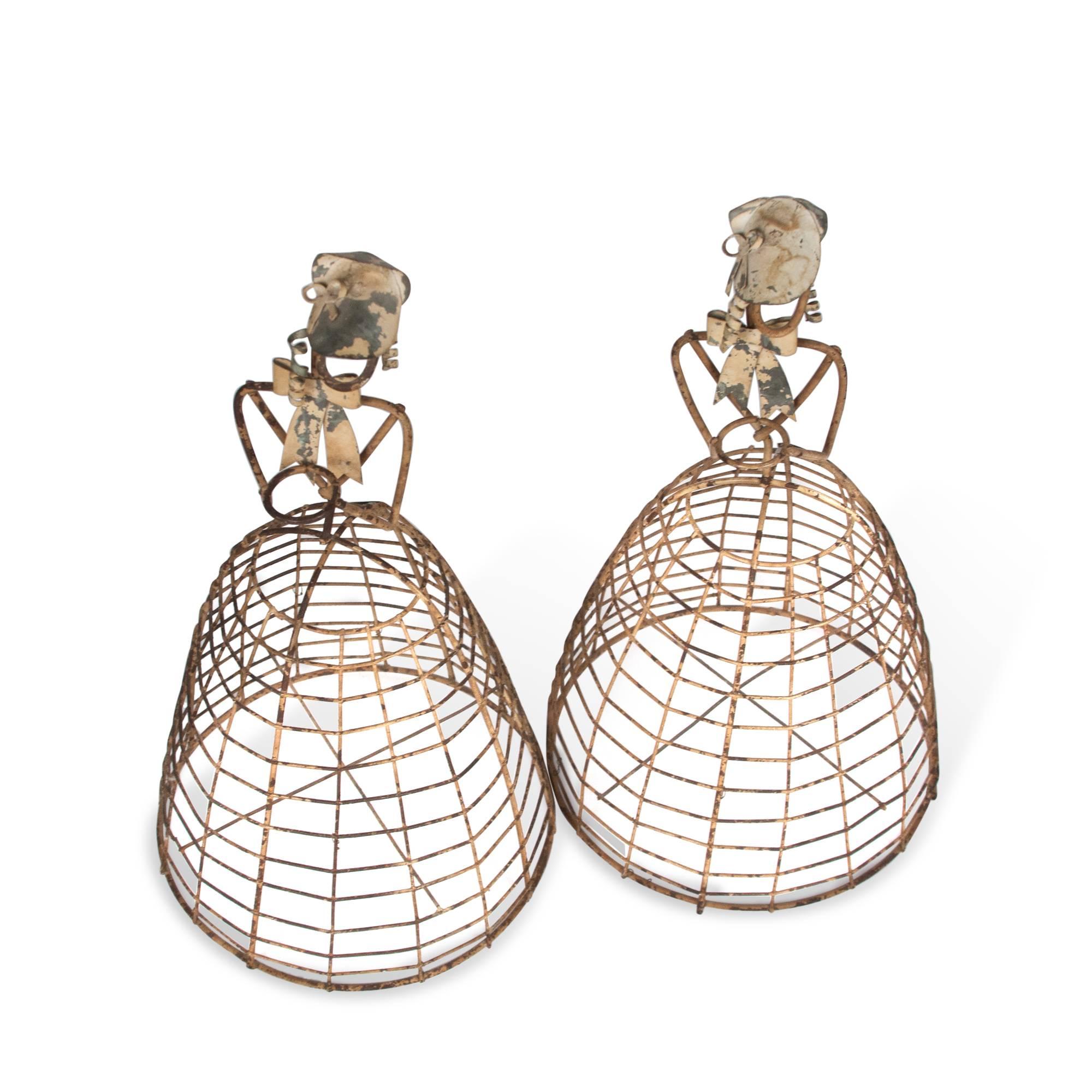 Two painted wire planters in the form of a woman in a dress, by Colette Gueden for Primavera, French, 1940s. Measures: 7” D x 13” H. (Item #3567)

Condition: Some wear and natural aging to metal, losses to paint, a couple detached elements.