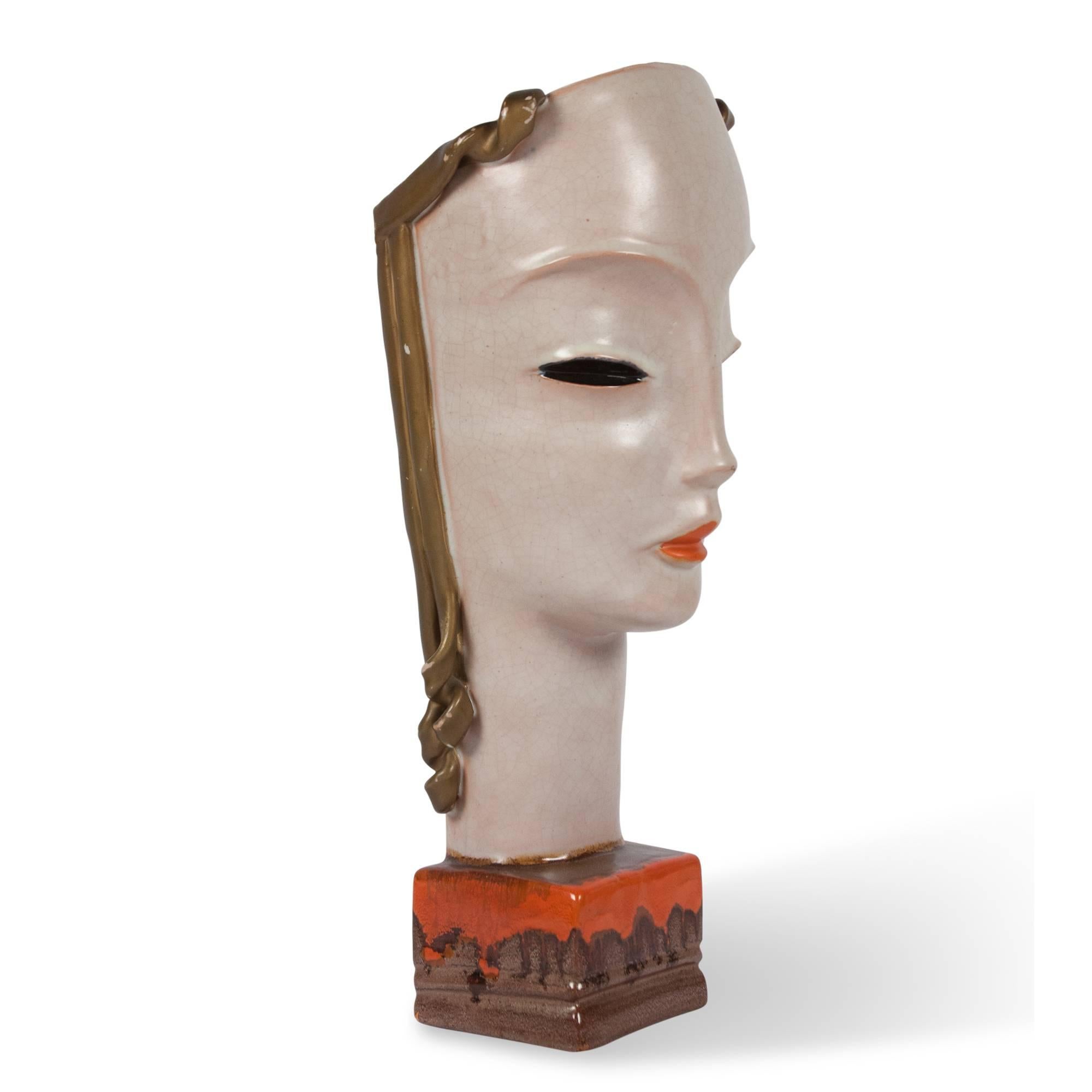 Painted ceramic sculpture of a female bust, in the Art Deco style by Goldscheider, Austria, late 1920s. Measures: 3 in. sq. base, 6 in. W, 24 in. H. 
  