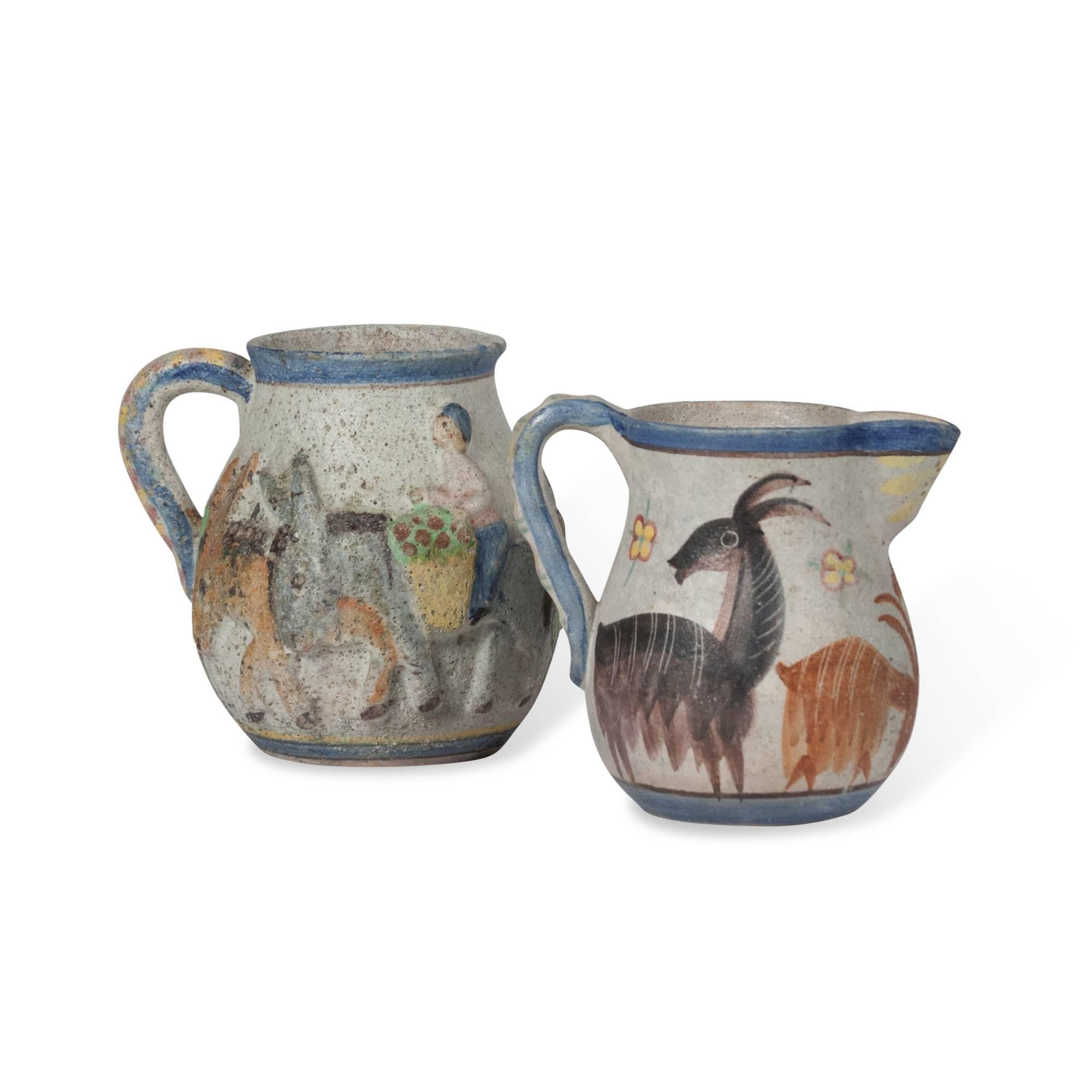 Two hand-painted ceramic pitchers by Guido Gambone, Italy, 1960s. Signed to the underside with his fish symbol. Measures: On left: 7.5 in W, 7.5 in H. On right: 7.25 in W, 7.25 in H. 
Price for the set of two. Also available separately, please