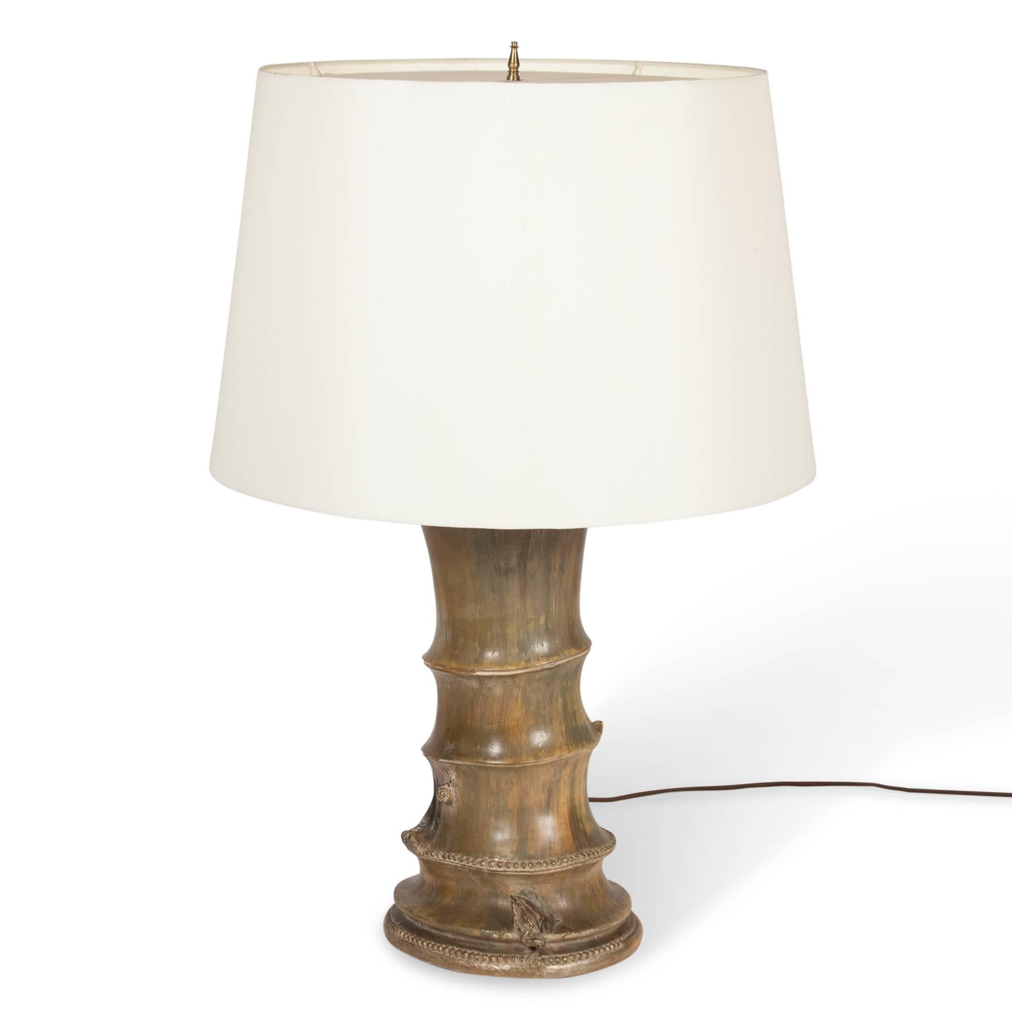 Mottled pale brown glazed ceramic table lamp, of tree trunk form with applied frog decoration by James Mont, American, 1950s. In custom silk shade. Measures: 9 ½ in. D, 31 ¾ in. H, 21 in. D shade at widest. 