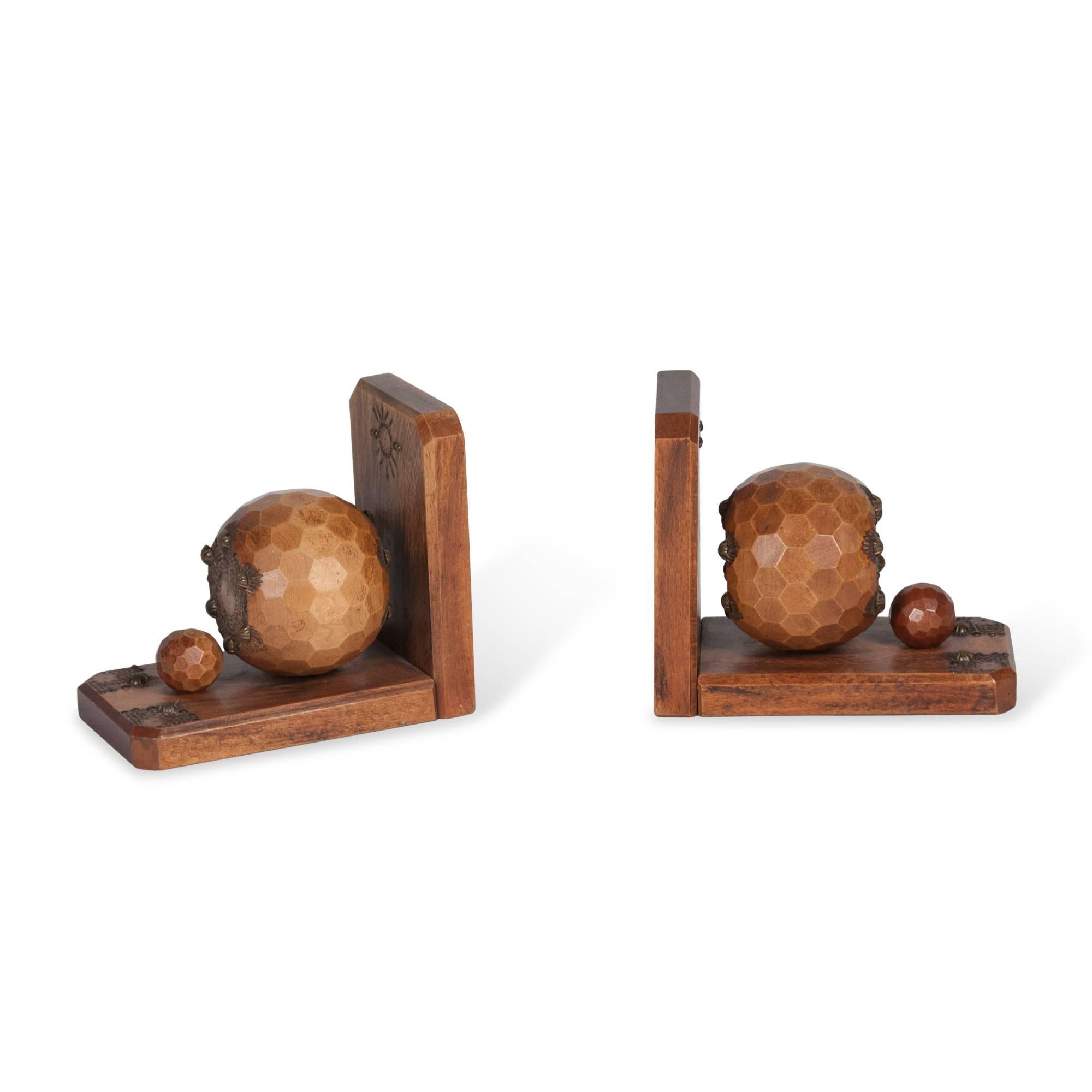 Pair of oak bookends, the faceted sphere mounted on an L-shaped base with brass decoration, French, circa 1930. Measures: 3.25 in. W, 6.5 in. D, 5.5 in. H.
