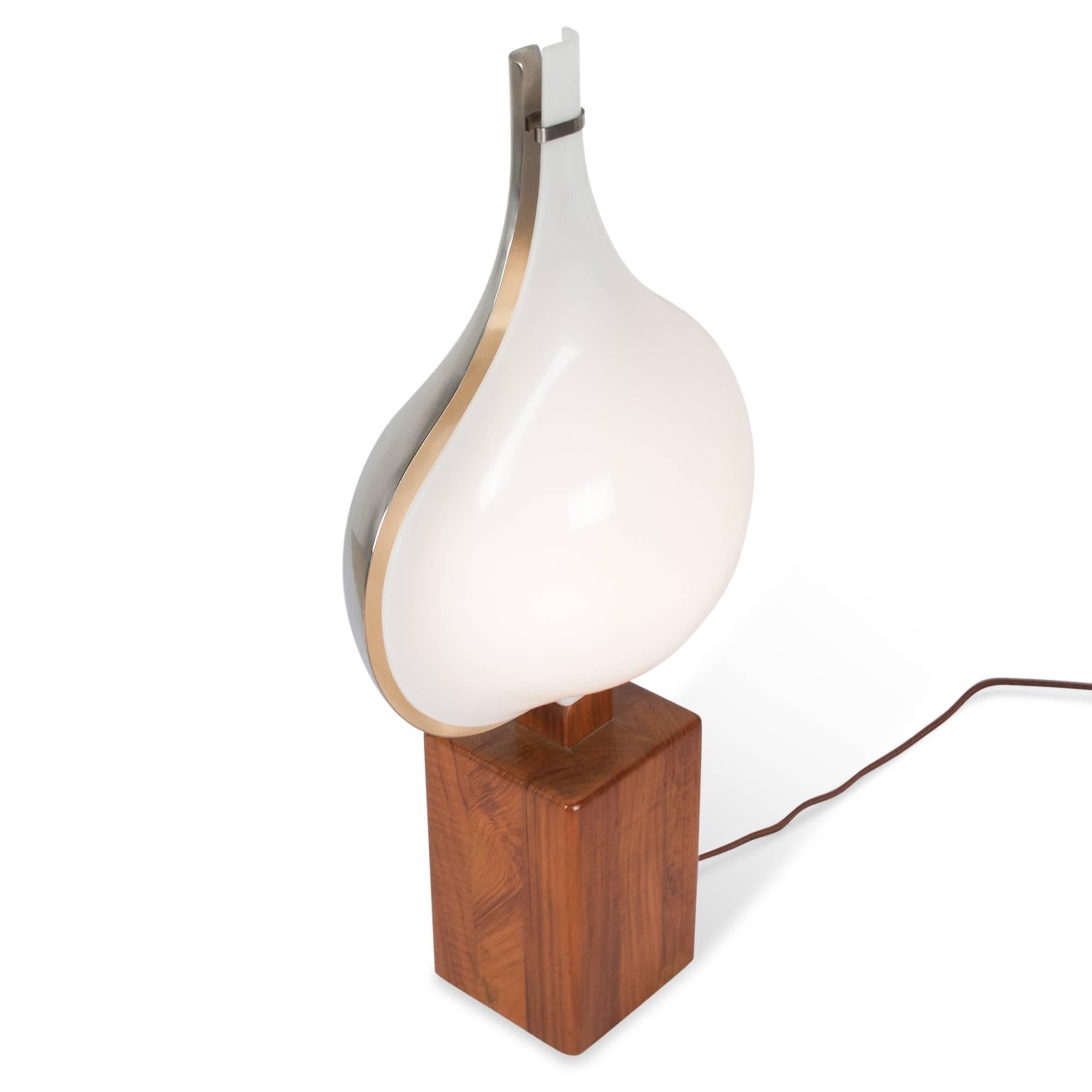 Teardrop shaped steel and white plastic illuminated element mounted on a walnut base, French, late 1960s. Measures: 4in. sq. base, 10in. W, 19in. H. 
 