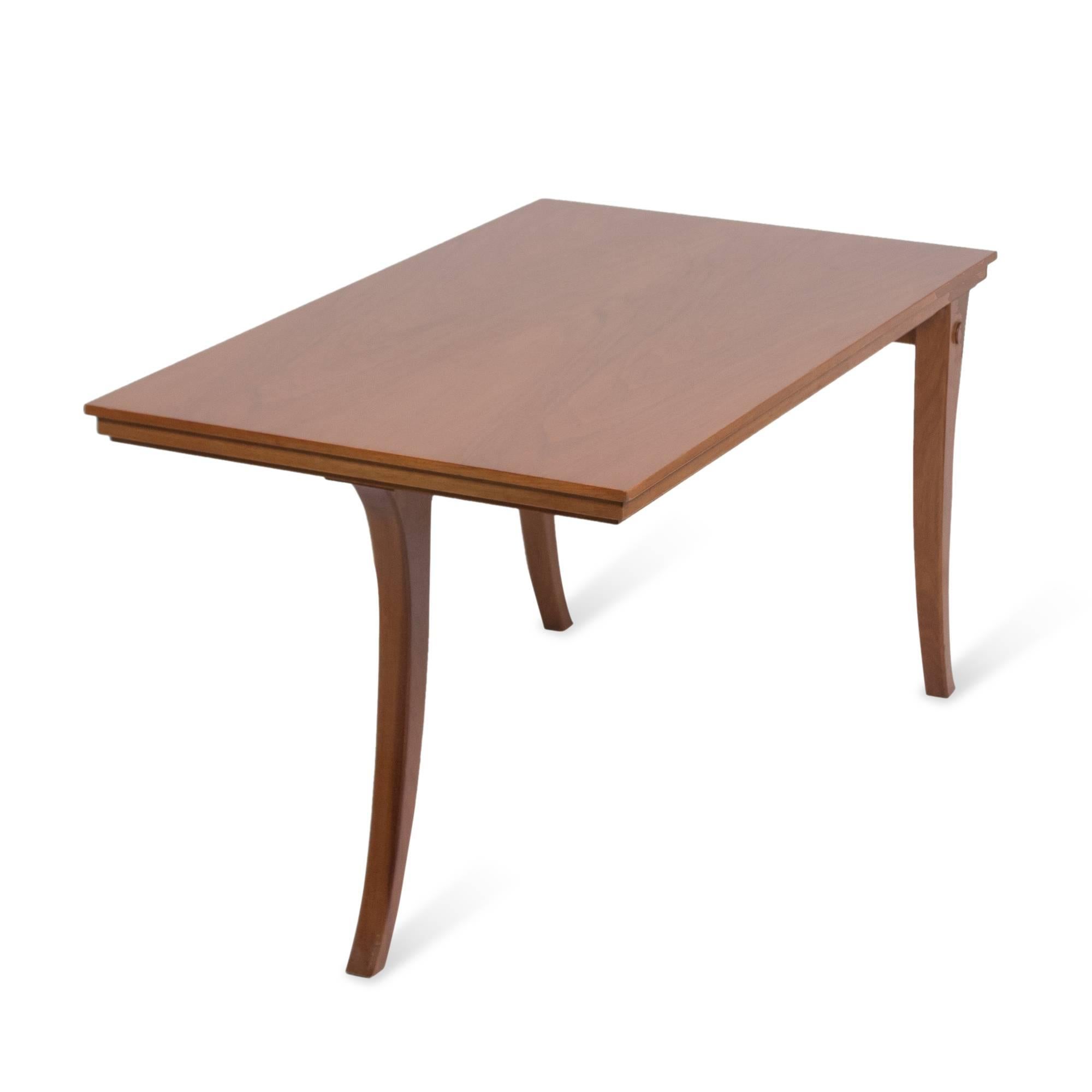 Solid walnut coffee or end table, of rectangular form, the surface supported by three tapered and slightly arced legs, by T.H Robsjohn-Gibbings for Saridis, American designer for Greek company, 1960s. 18