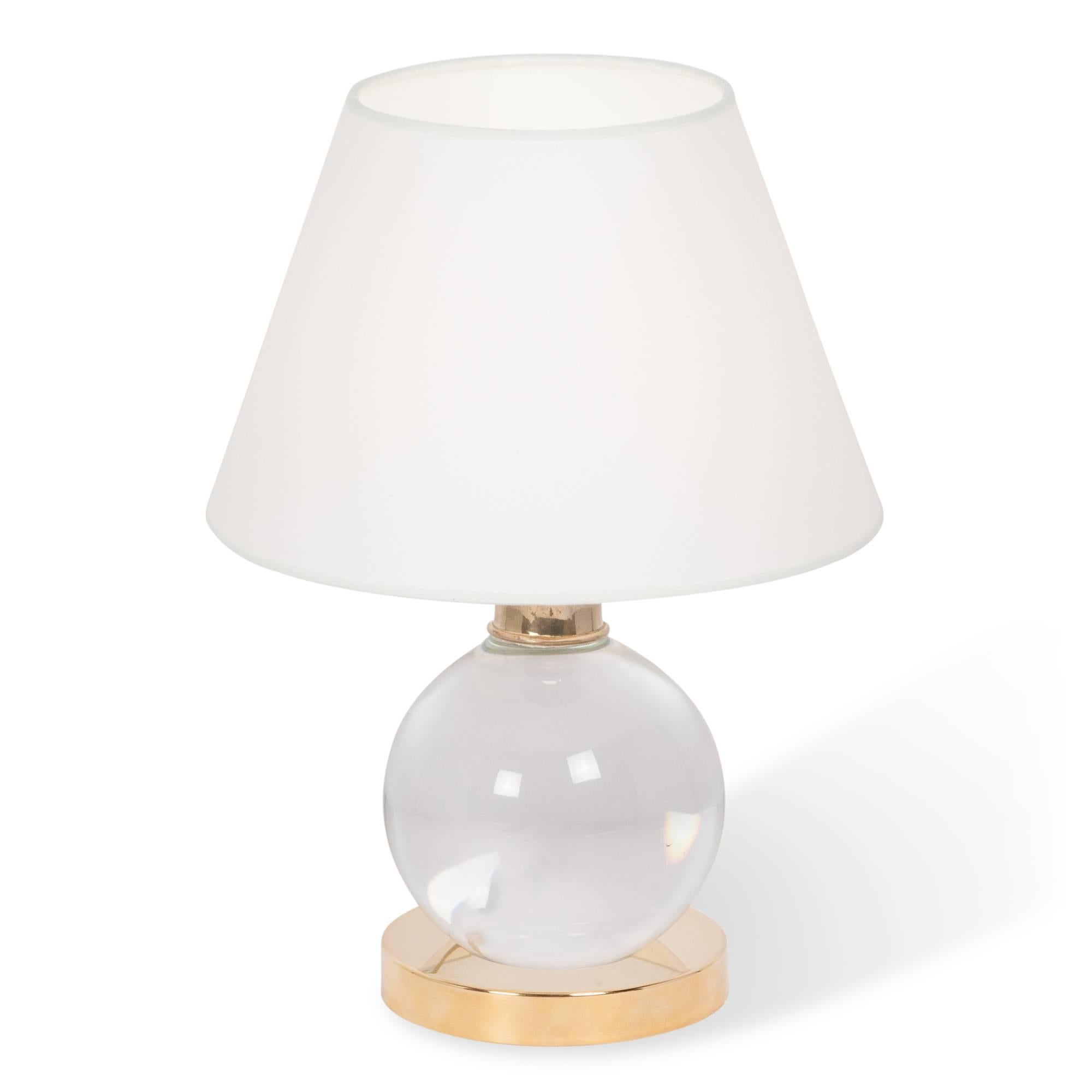 Crystal ball table lamp, pivotable in all directions on the disc base, in silk shade. Custom after a design by Jacques Adnet, limited production, 2000s. Overall height 13 in, base has 5 in diameter. Bottom diameter of shade is 9 in.

 
