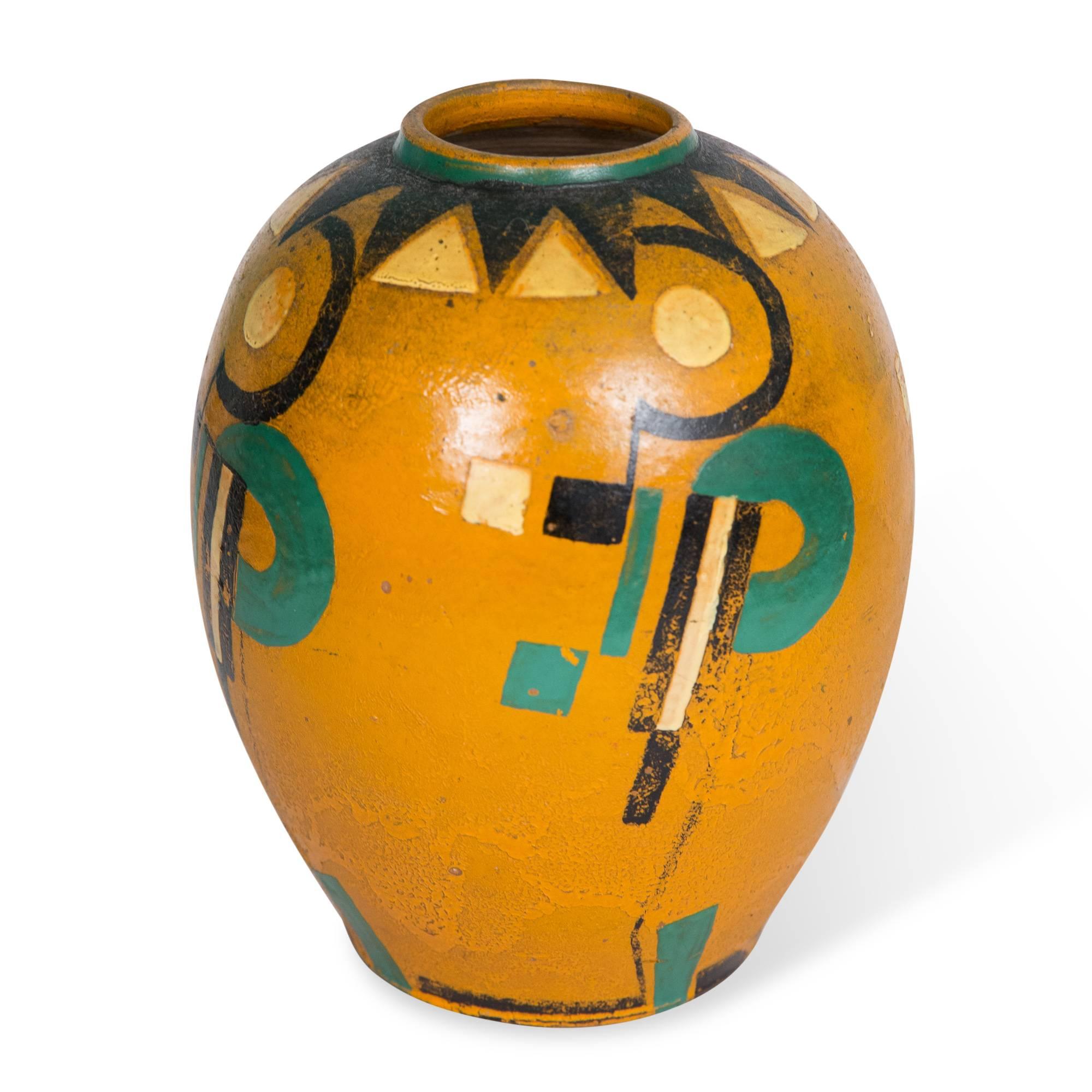Bulbous form ceramic vase with Constructivist or Bauhaus style geometric decoration over the primarily orange glaze, Germany, circa 1930. Unsigned. Measures: Height 9 1/2 in, largest diameter 7 in, diameter of opening 2 1/2 in. (sats)