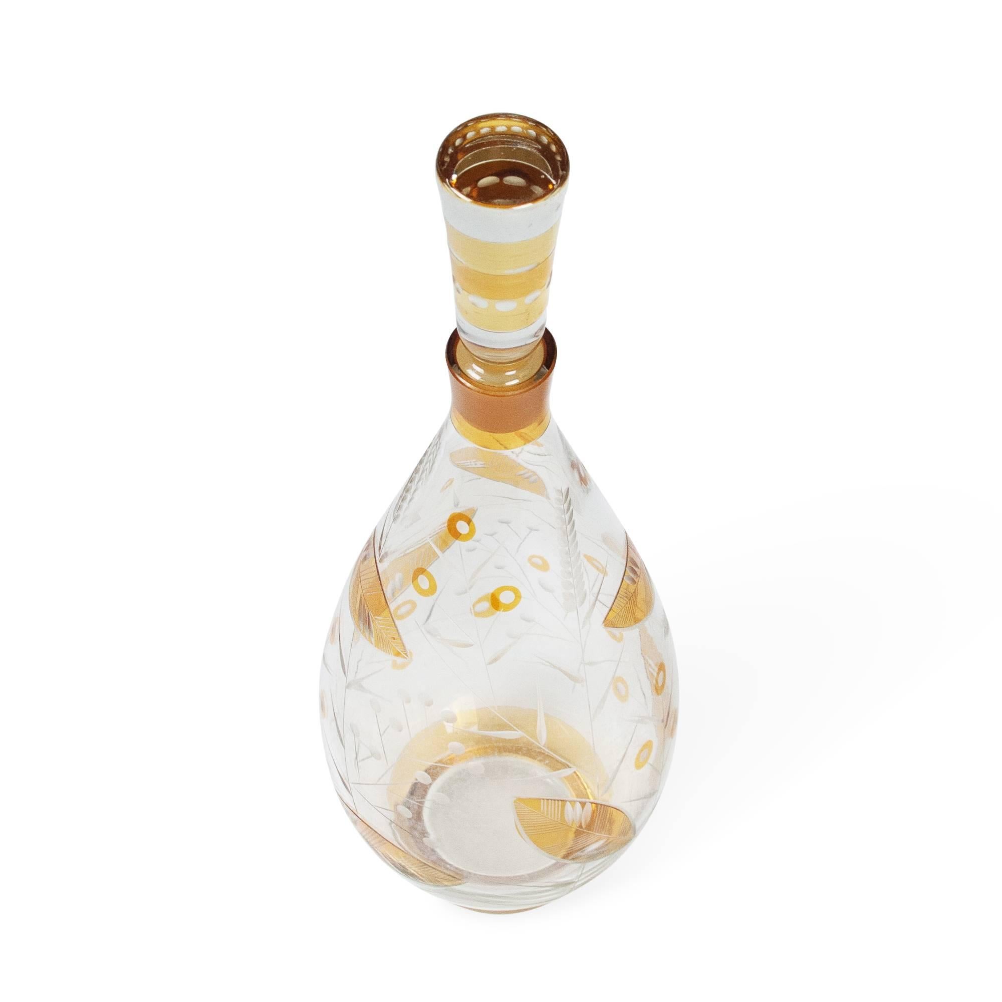 Clear glass bottle with stopper, having amber foliate coloring, Bohemian, early 20th century. Measures: 14 in. height (including stopper), 4 1/2 in. diameter.