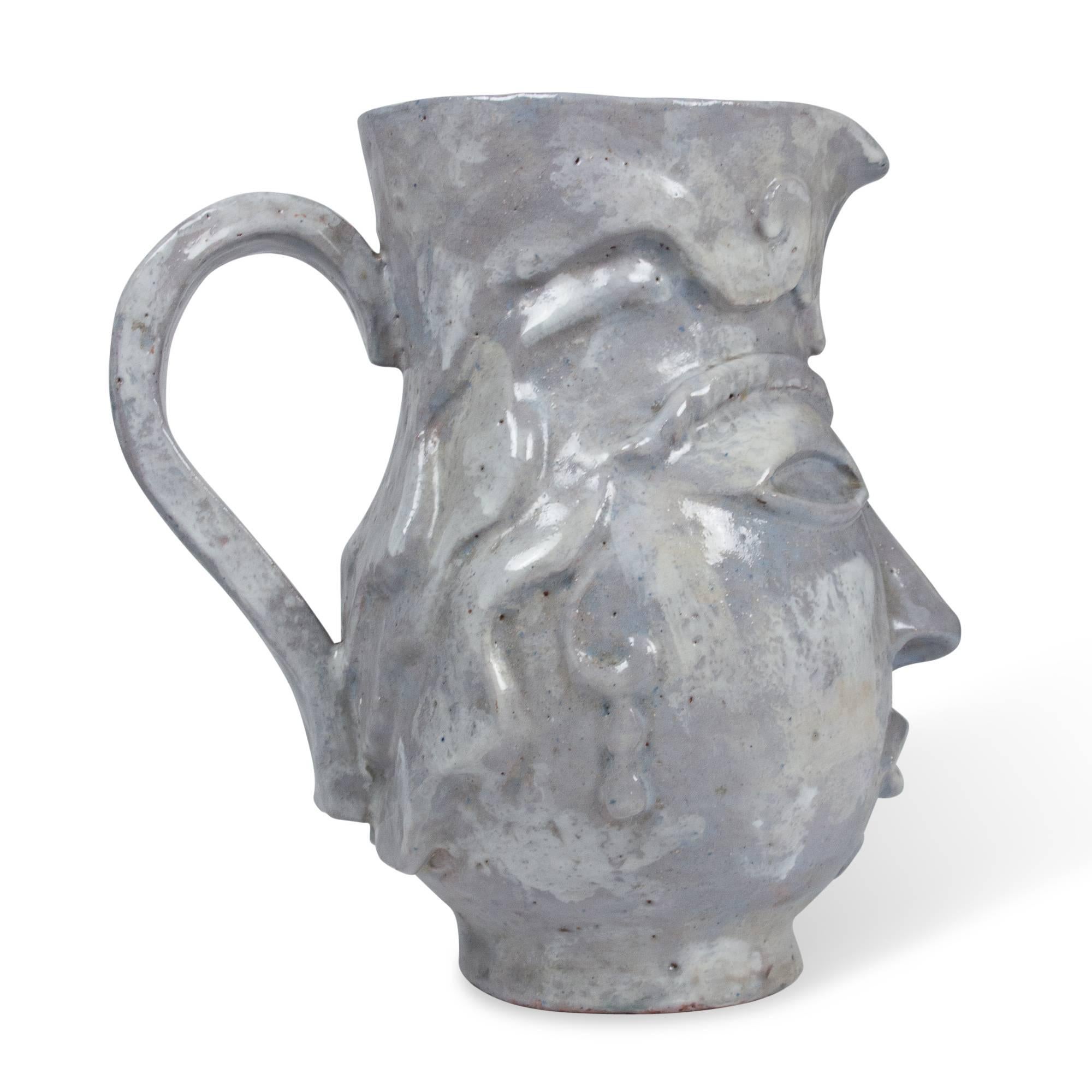 Glazed ceramic pitcher depicting a face, France, 1930s. Measures: 9 2/3 in. height, 6 in. width, 9 in. depth. 