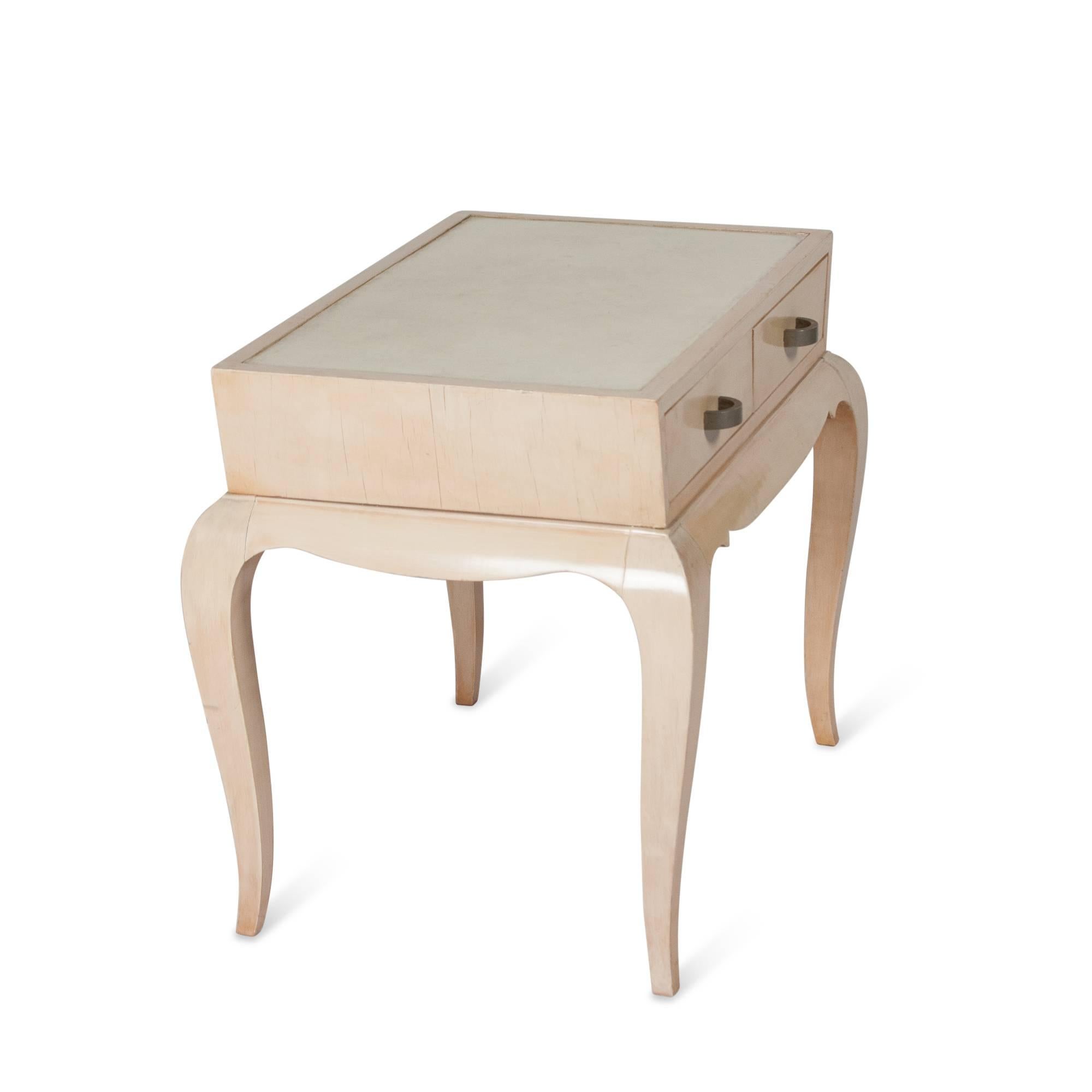 Bleached oak end table with parchment top surface and two drawers, in the style of Andre Arbus, French, 1940s. Measures: Width 22 1/2 in, depth 16 in, height 19 in.