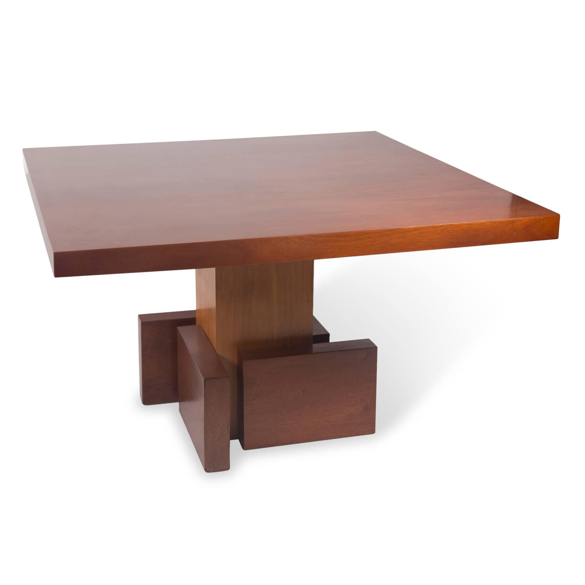 Square mahogany dining or kitchen table, the surface mounted on a staggered cubist inspired pedestal base, France, 1930s. Measures: 47 in square, height 29 in.