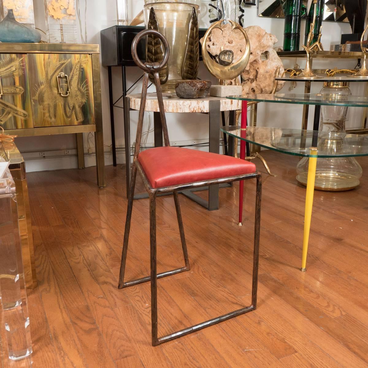 Pair of unusual iron stools with ring handle details.