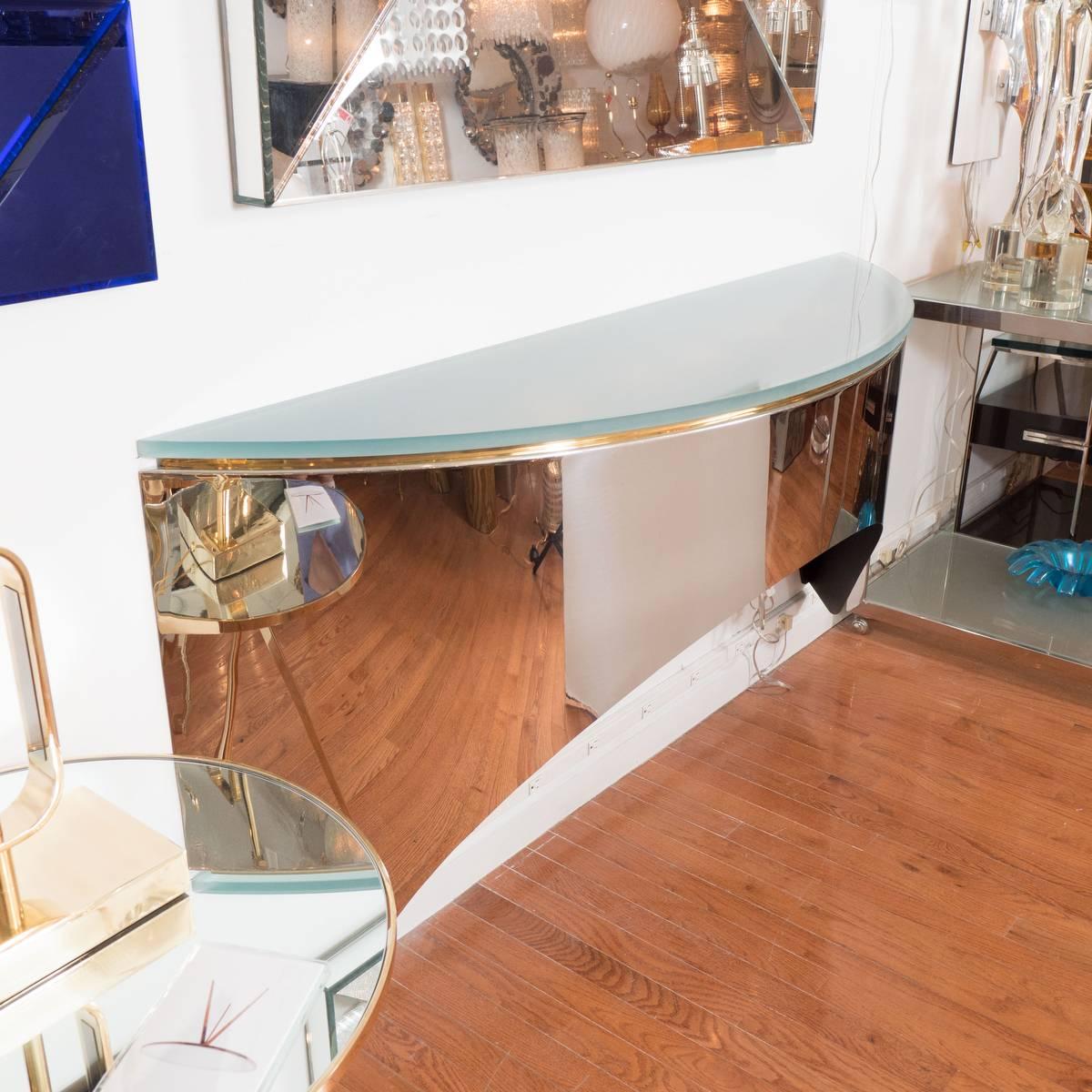 Wall-mounted, interior-lit console tables with polished nickel, brass and frosted glass details in the style of Karl Springer.