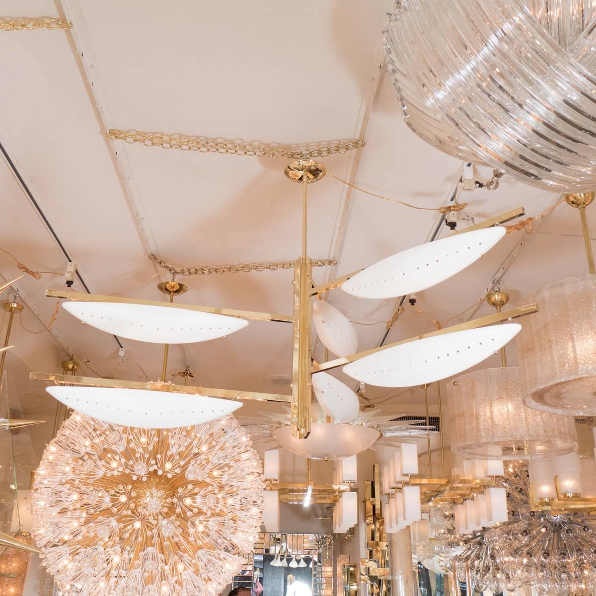 Six-light brass chandelier featuring ivory enameled pierced shades.