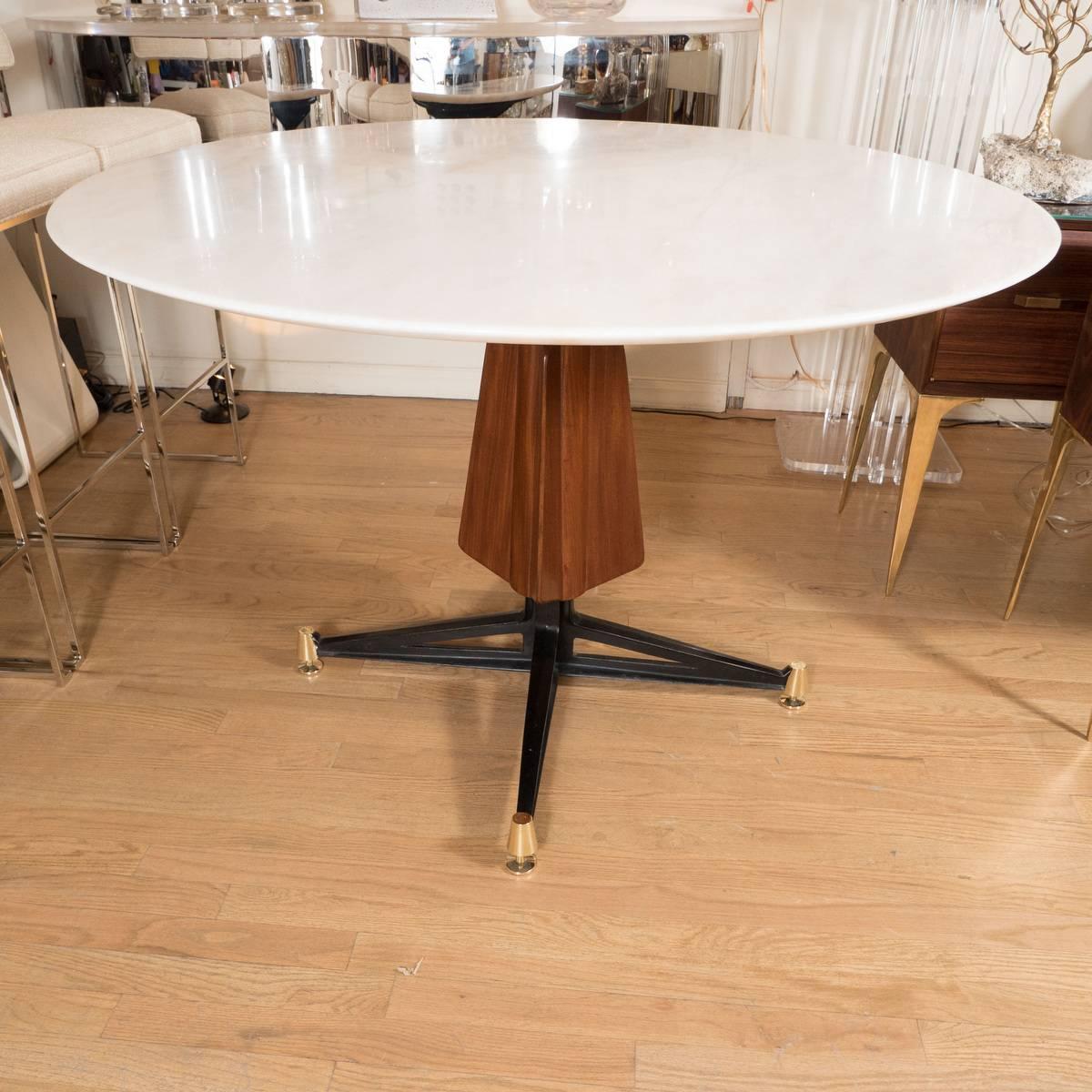 Circular marble table with blackened iron, brass, and wood base.