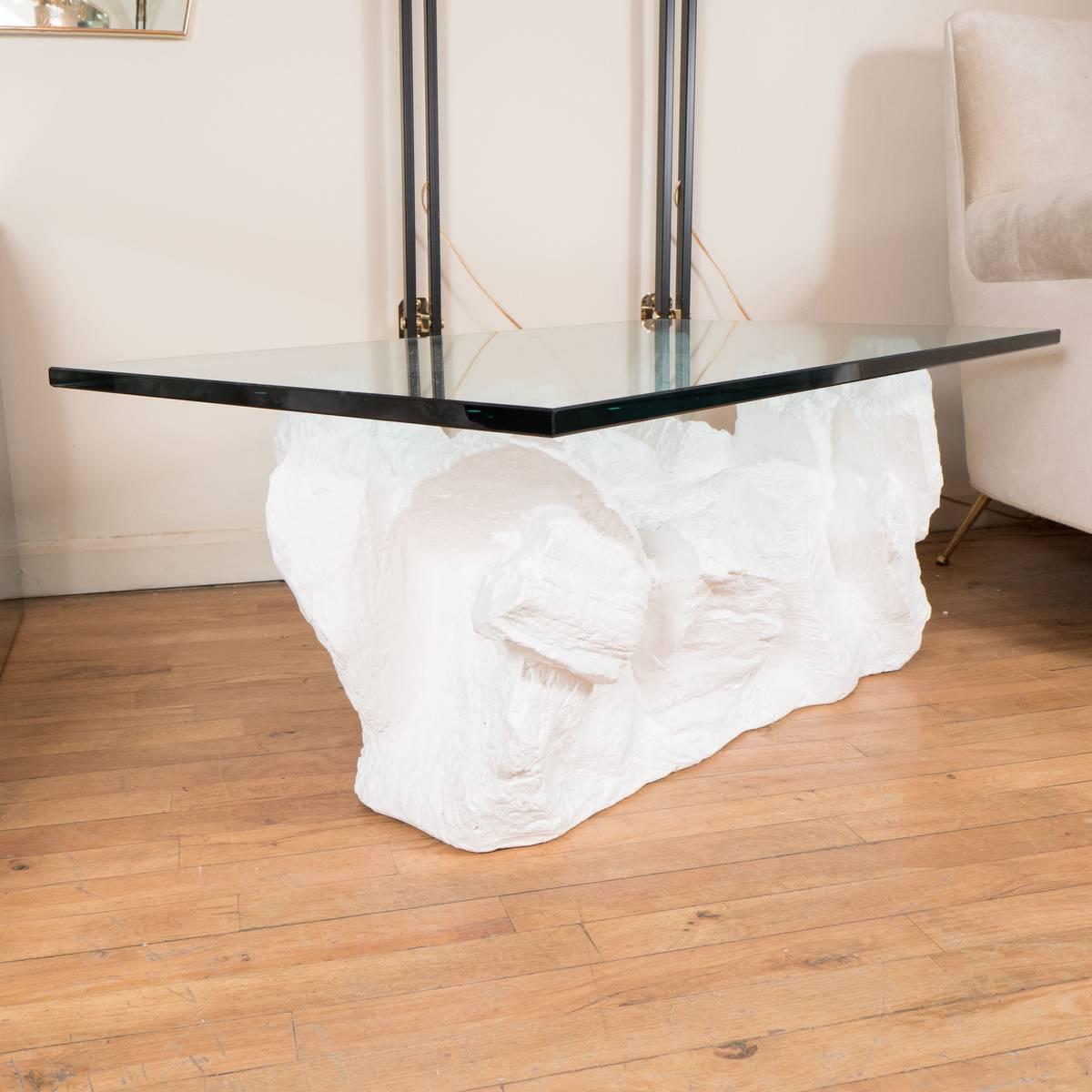 Composition rock form coffee table with rectangular glass top.