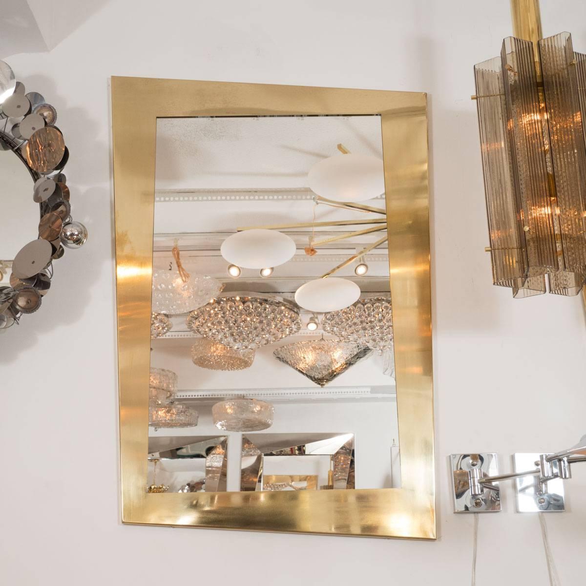 Polished brass trapezoidal mirror.