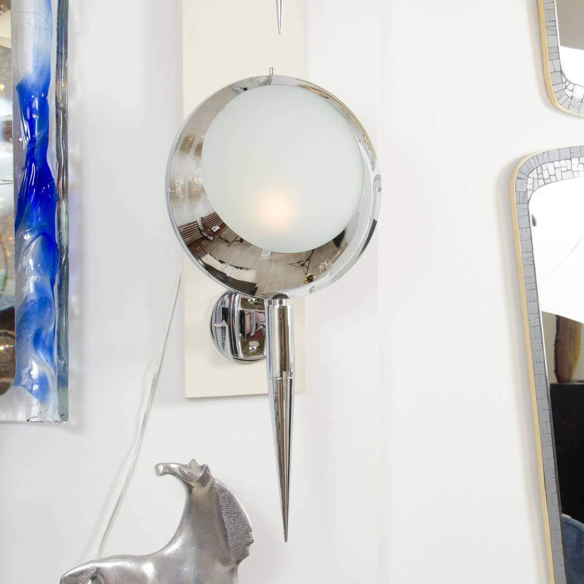 Pair of chrome circular sconces with frosted glass shades and conical arms in the manner of Stilnovo.