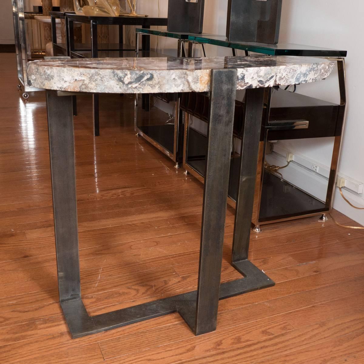 Cross-cut, rock crystal slab table with metal base.