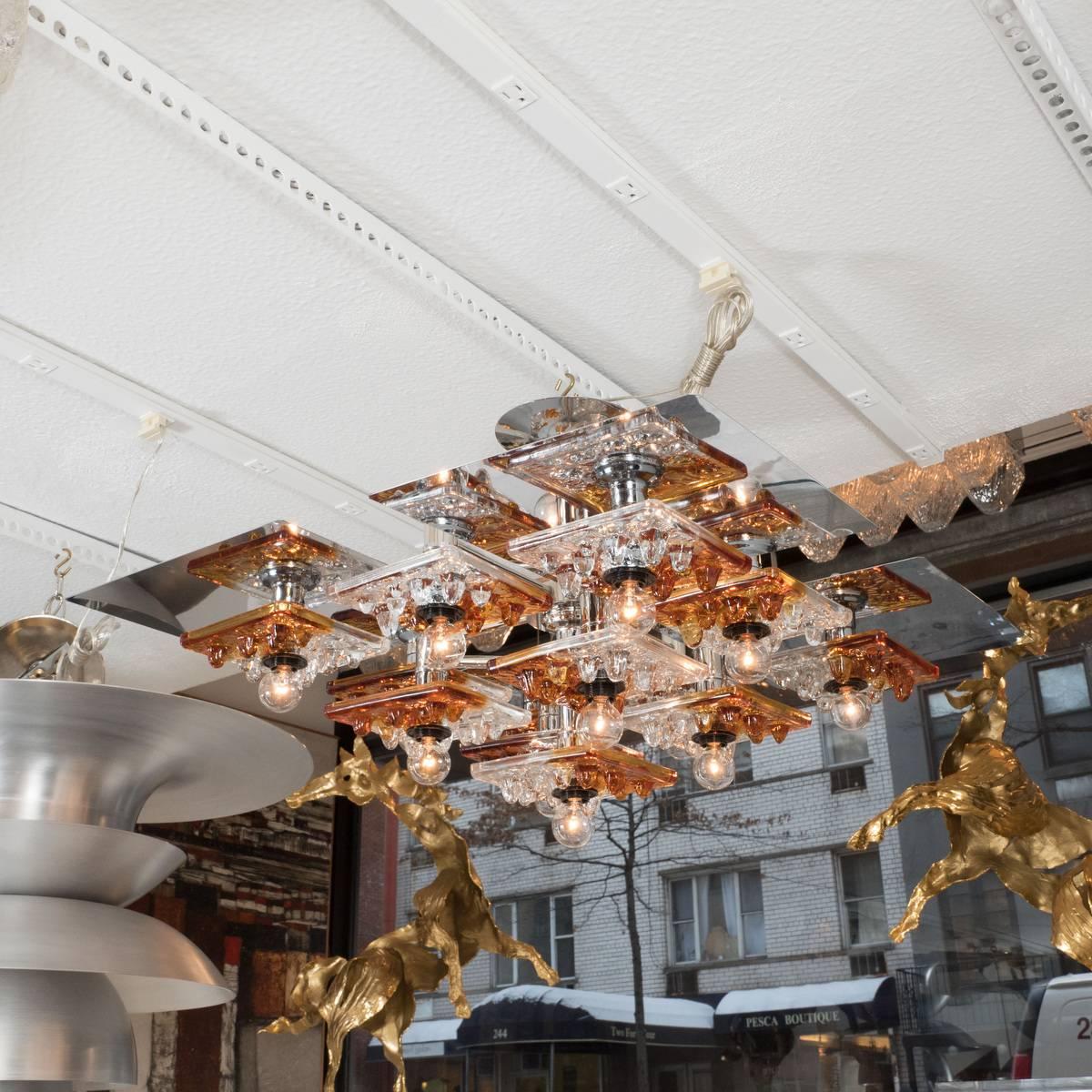 Tiered polished nickel chandelier with clear and amber Murano glass tile details by Mazzega.
