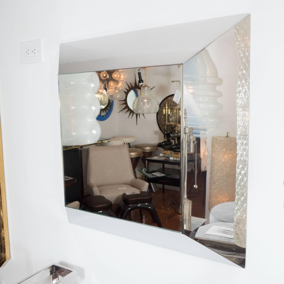 Stylized box mirror with sloped chrome surround.