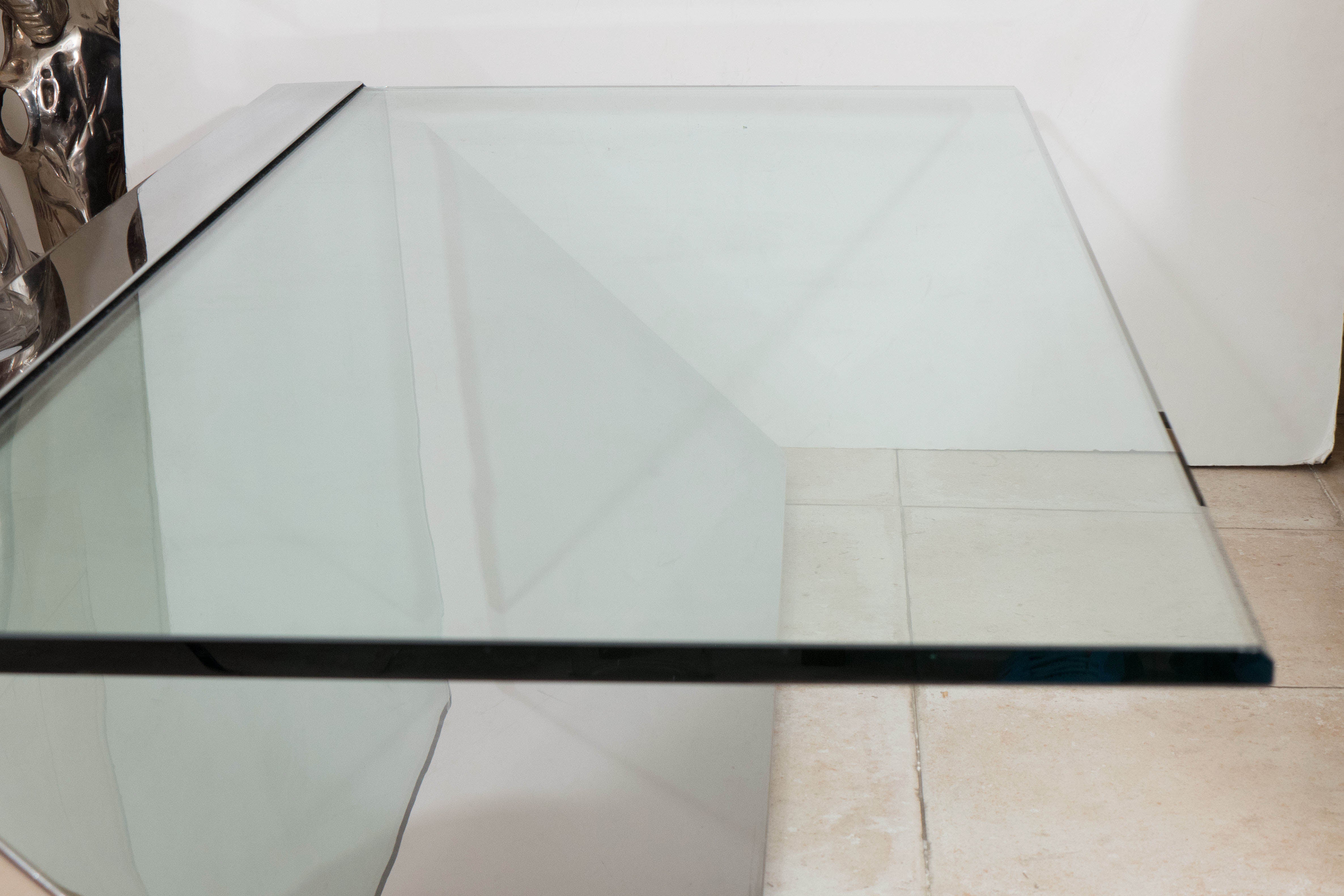 Cantilevered stainless steel coffee table with glass top by J. Wade Beam for Brueton.