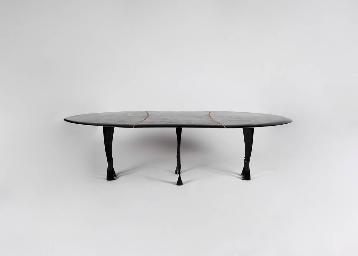 Named for Achilles, the hero of Homer’s Illiad, this formidable table has a blackened hand-hammered, shield-like top (separated into three parts by two ornamental bands), and feet modeled after those of a horse.
 