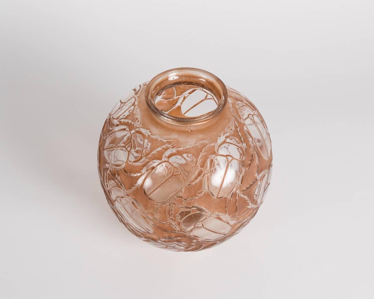 Molded glass vase with original sepia patina by French designer René Lalique.

Signed: R Lalique, France.