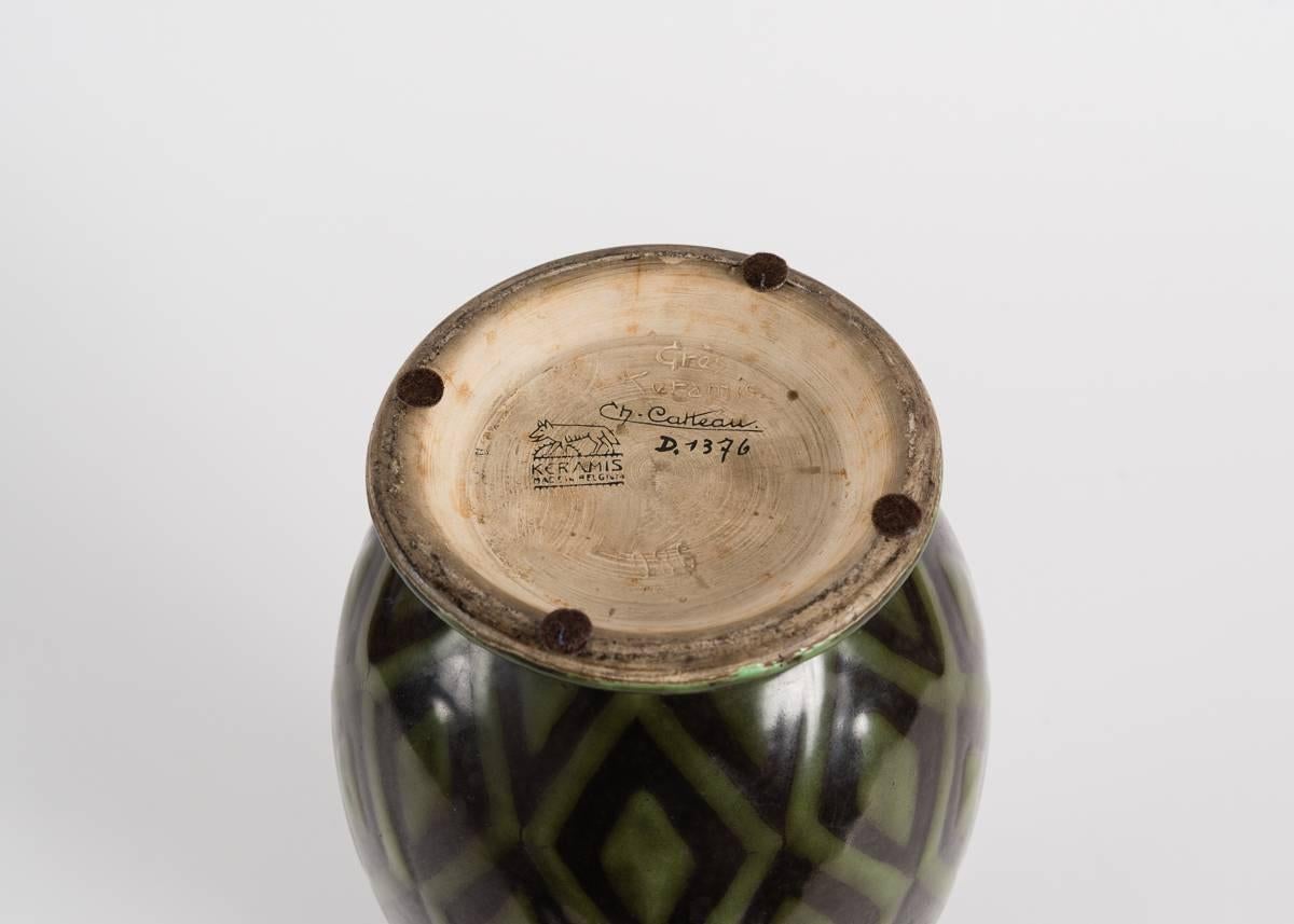 Art Deco vase by Charles Catteau.

Signed: Ch. Catteau
Inscribed: Keramis made in Belgium.
Marked: D. 1376.