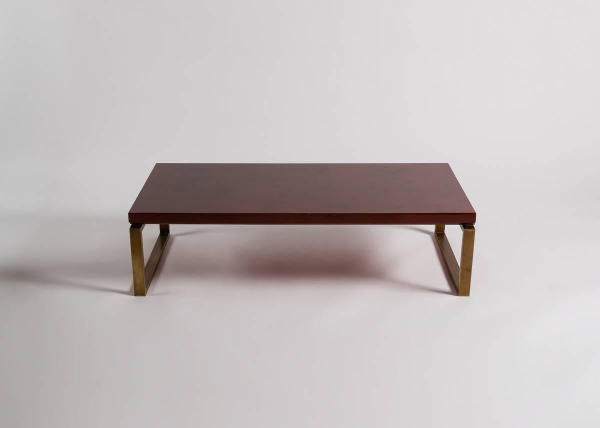 Red lacquered wood and metal coffee table by Maison Charles.