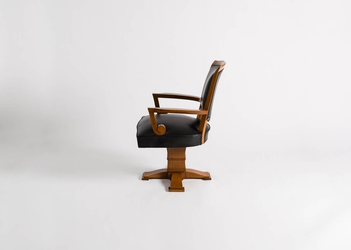 This desk chair, designed by Jules Leleu a year after the war, has deco accents on its arms, and stabile base upon which it swivels.