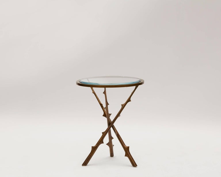 Contemporary tripod side table by Hervé van der Straeten in patinated bronze with a glass top.