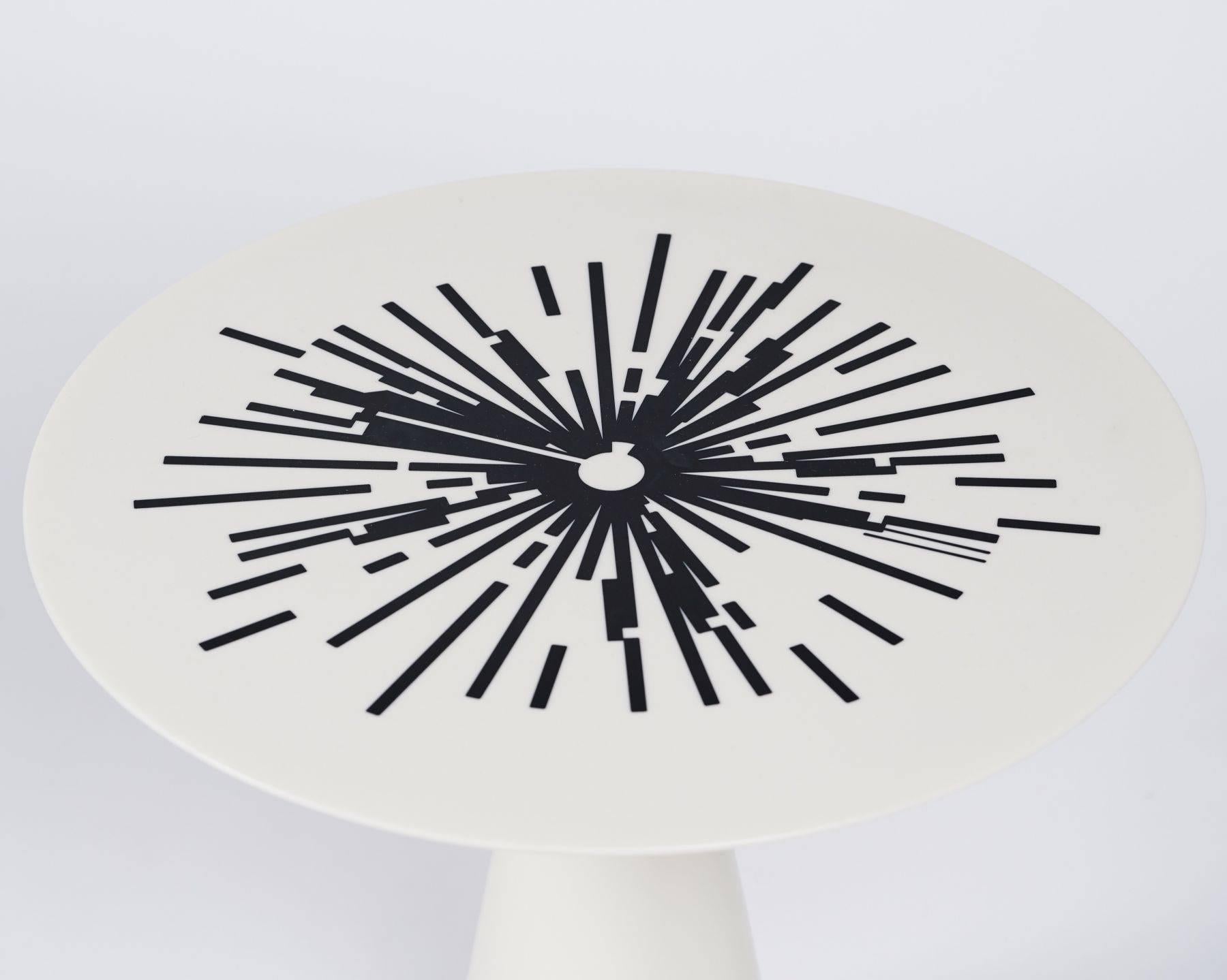 This one of a  set of nesting occasional tables, made of a silky smooth, laminated Corian, plays with the contrast of night with day, of light with darkness. The pieces are entirely black and white and adorned with intricate, laser cut and bronze
