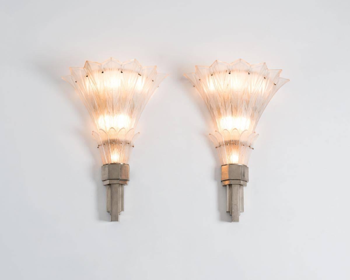 A fine pair of sconces by Sabino in frosted glass and nickel-plated bronze

Provenance: Commissioned in 1927 for the Arcadian Court Restaurant in Simpson's Department store, Toronto, Canada.

