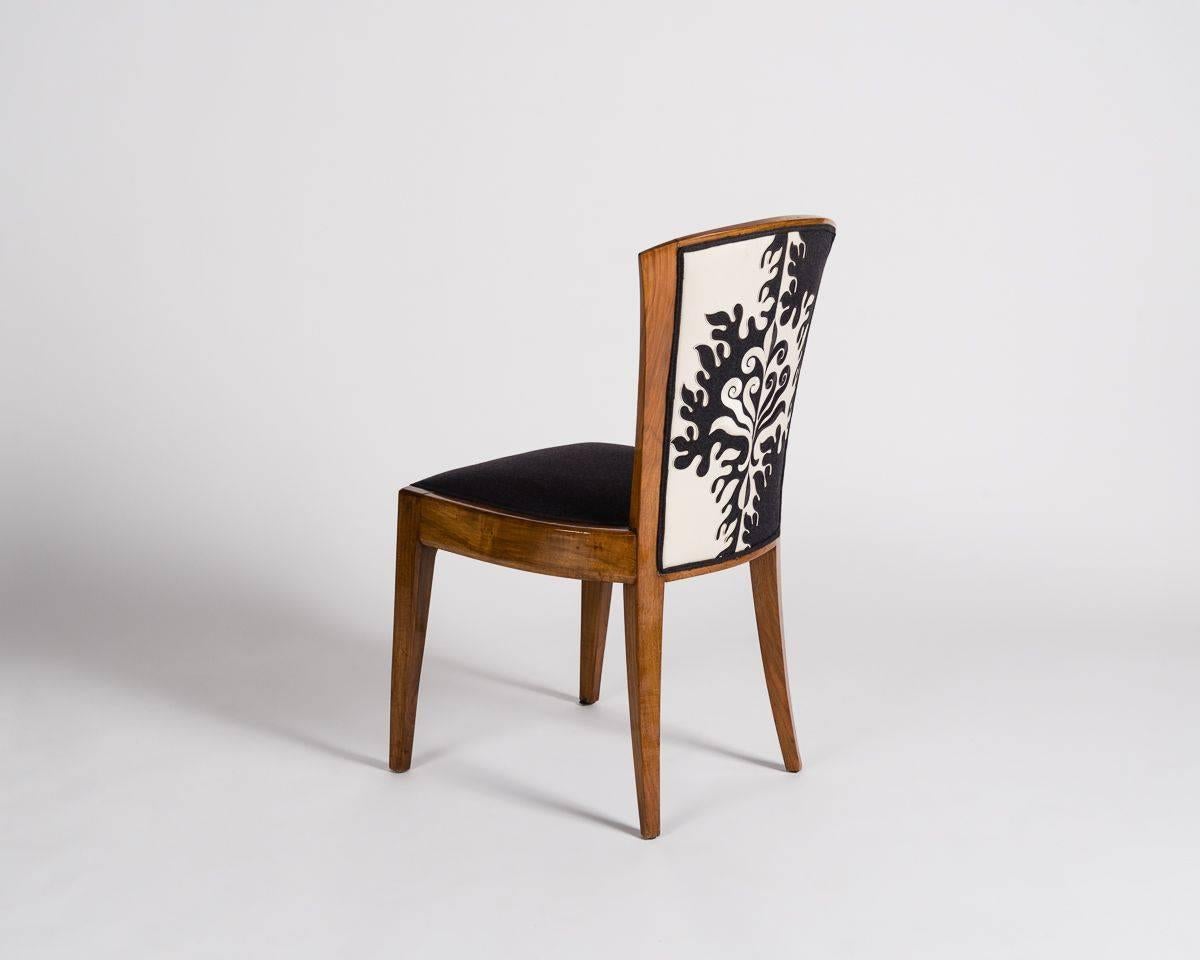 This model was executed by Dominique with different variations as early as 1924. Each chair in this freshly reupholstered set flares at its top, balancing a wide seat.