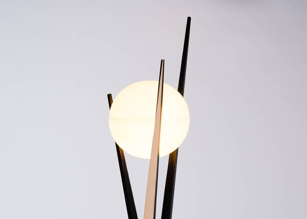 A re-imagining of Salvagni's Darts chandelier, Divo is a standing lamp composed of three cast bronze spears that intertwine, supporting at their ends a luminous hand-carved onyx shade.

Limited edition of 20.