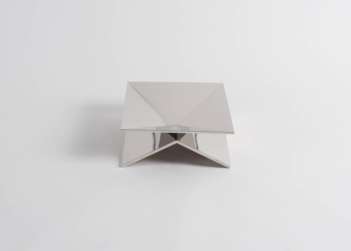 One of a limited edition of thirty, this centerpiece by master silversmiths Juan and Paloma Garrido of Spain is composed entirely of nickel plated triangles. The many planes and angles of these fitted shapes generate a remarkable display of light,