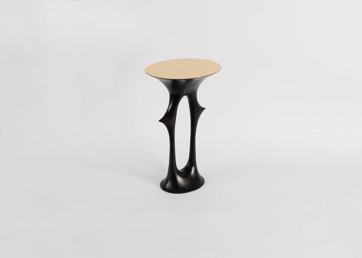 A side table with a solid, patinated bronze base, a polished bronze top and, despite its thorn motif (familiar to the work of van der Straeten) a shape reminiscent of the human form.