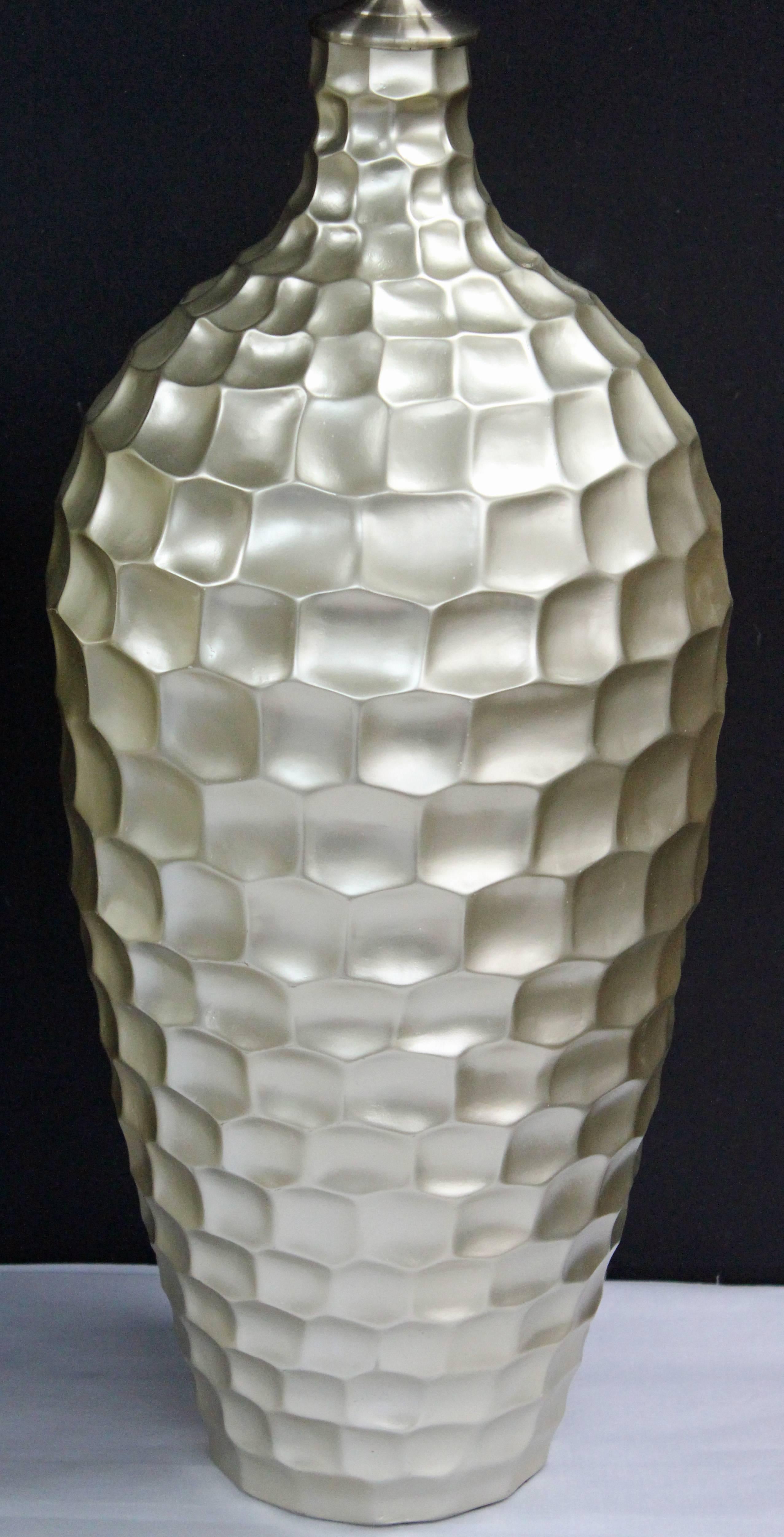 Pair of large textured ceramic vessels with lamp application. Finished in a satin pale gold, the vessels stand at 23