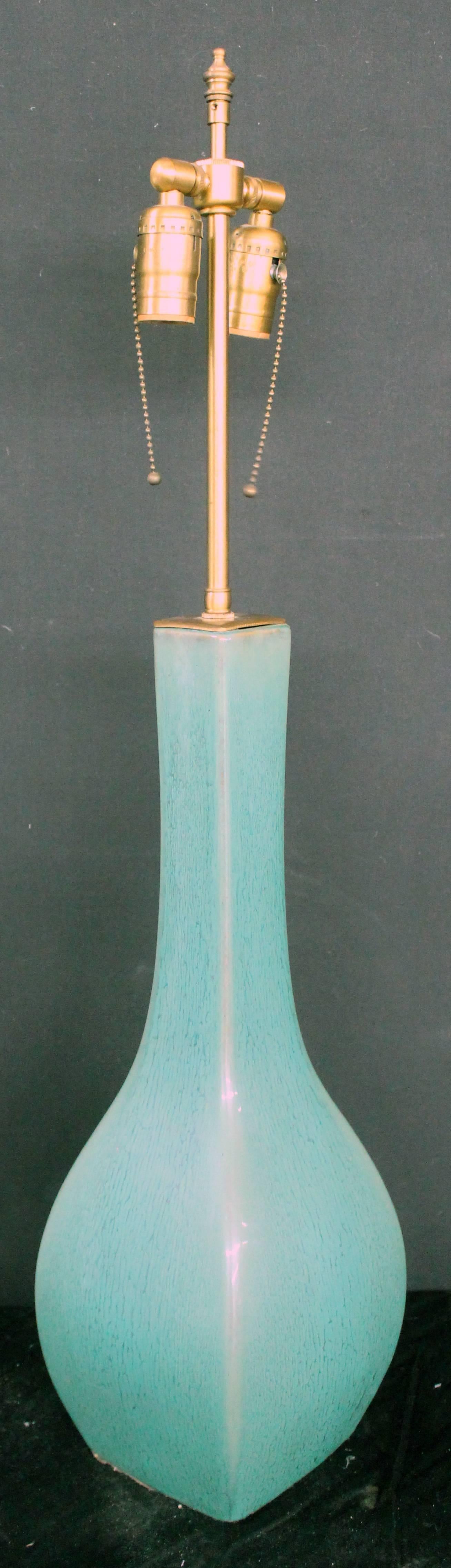A long neck ceramic glazed vase with Lamp application.