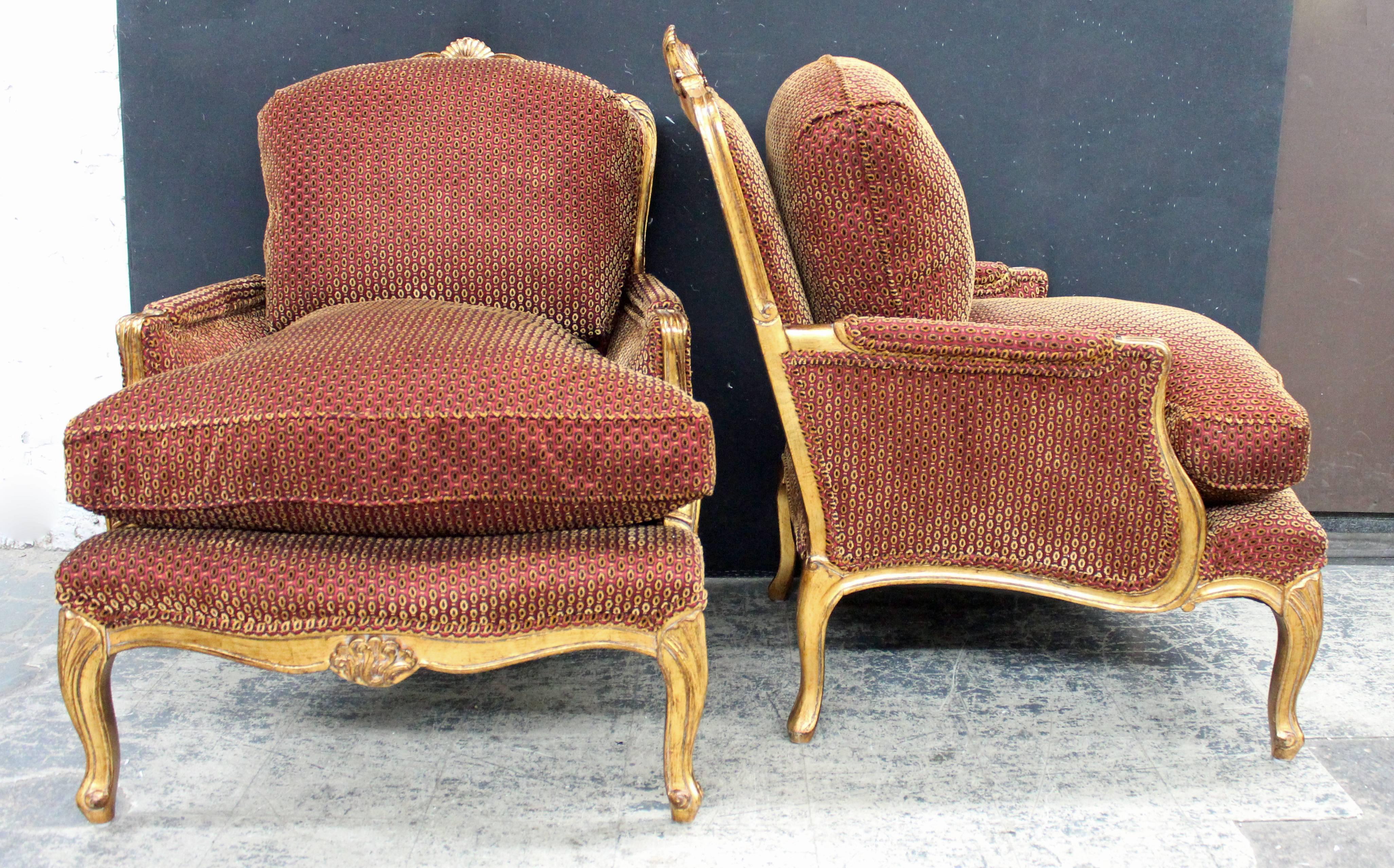 Pair of gilded French Louis XV bergères in a rich sculpted velvet. New upholstery work and fabric. Arm height is 22