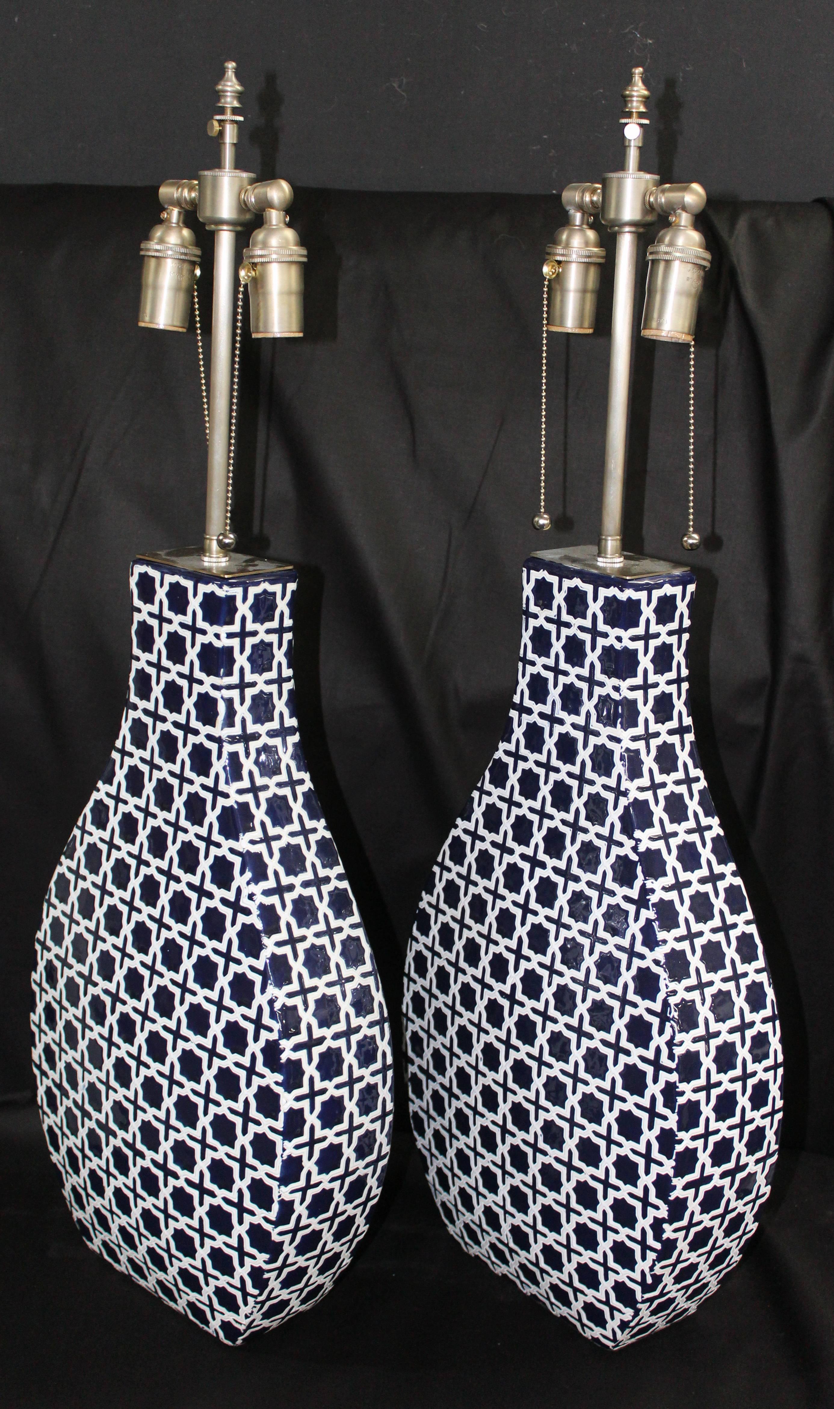 Large pair of ceramic vessels in cobalt and white with lamp application. The vessels are newly wired with dual control chains. The vessel height is 20 1/2
