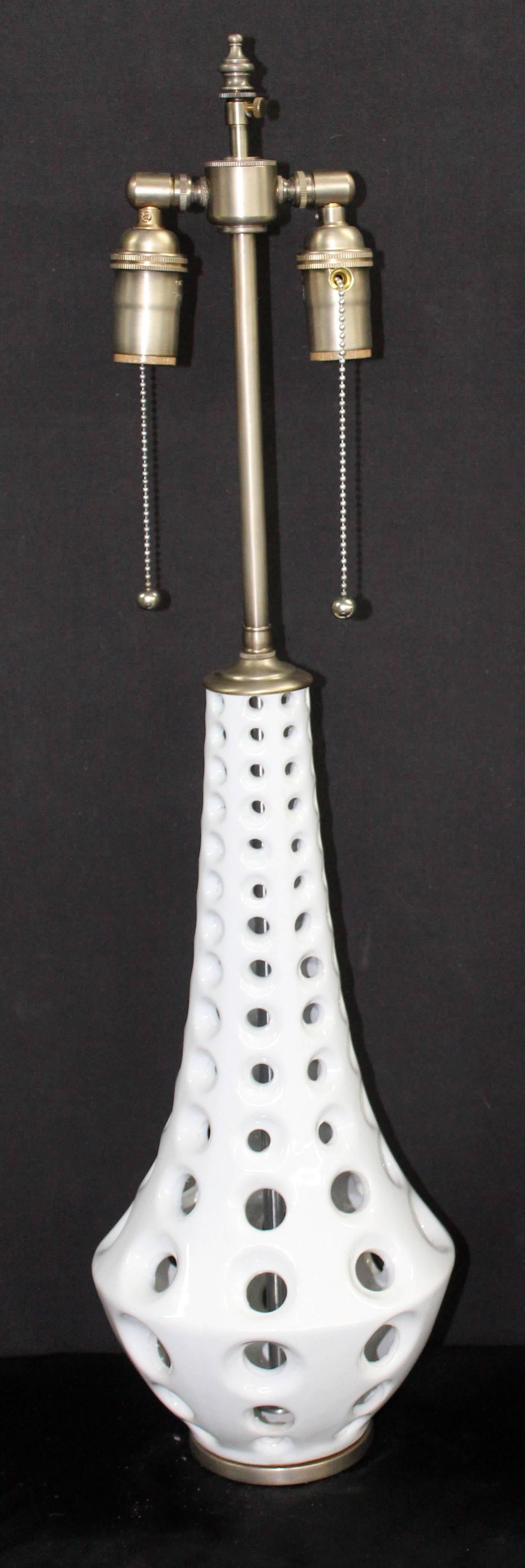Unique pair of Mid-Century ceramic vessels with lamp application. The vessels height is 15". The shade post height is 27" with an extendable 3" adjuster the hardware is in brushed nickel. The lamps are newly wired and will accommodate