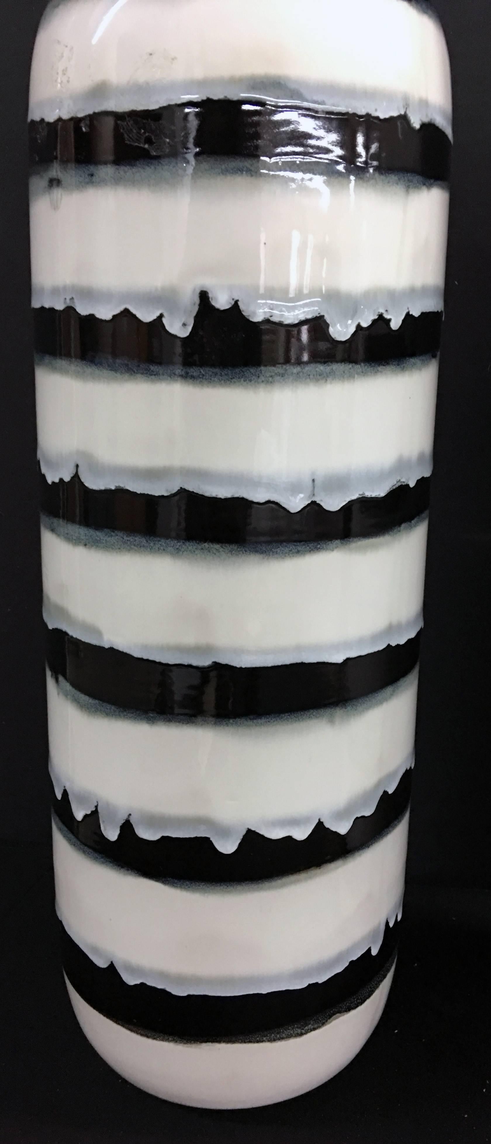 Unique pair of tall hand-painted and glazed vessels with lamp application. The lamps are newly wired. The hardware is Brushed nickel with dual sockets and individually controlled pulls. The vessels are 25