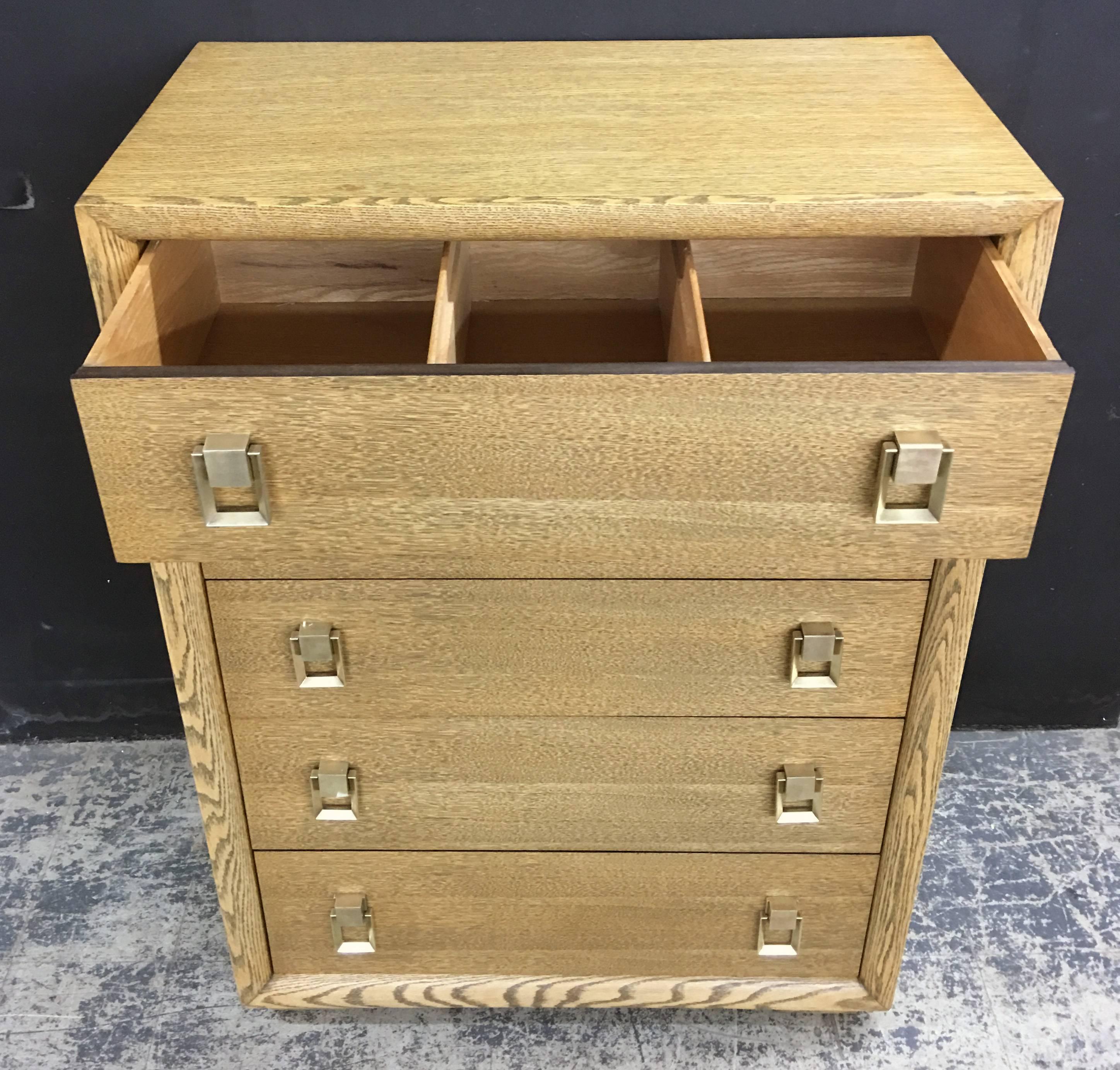 Fully restored and refinished Gilbert-Rohde rift oak dresser with original brass hardware. The dresser has five drawers of equal size, the first two of which are divided into three sections. Measures: Each drawer face is 8