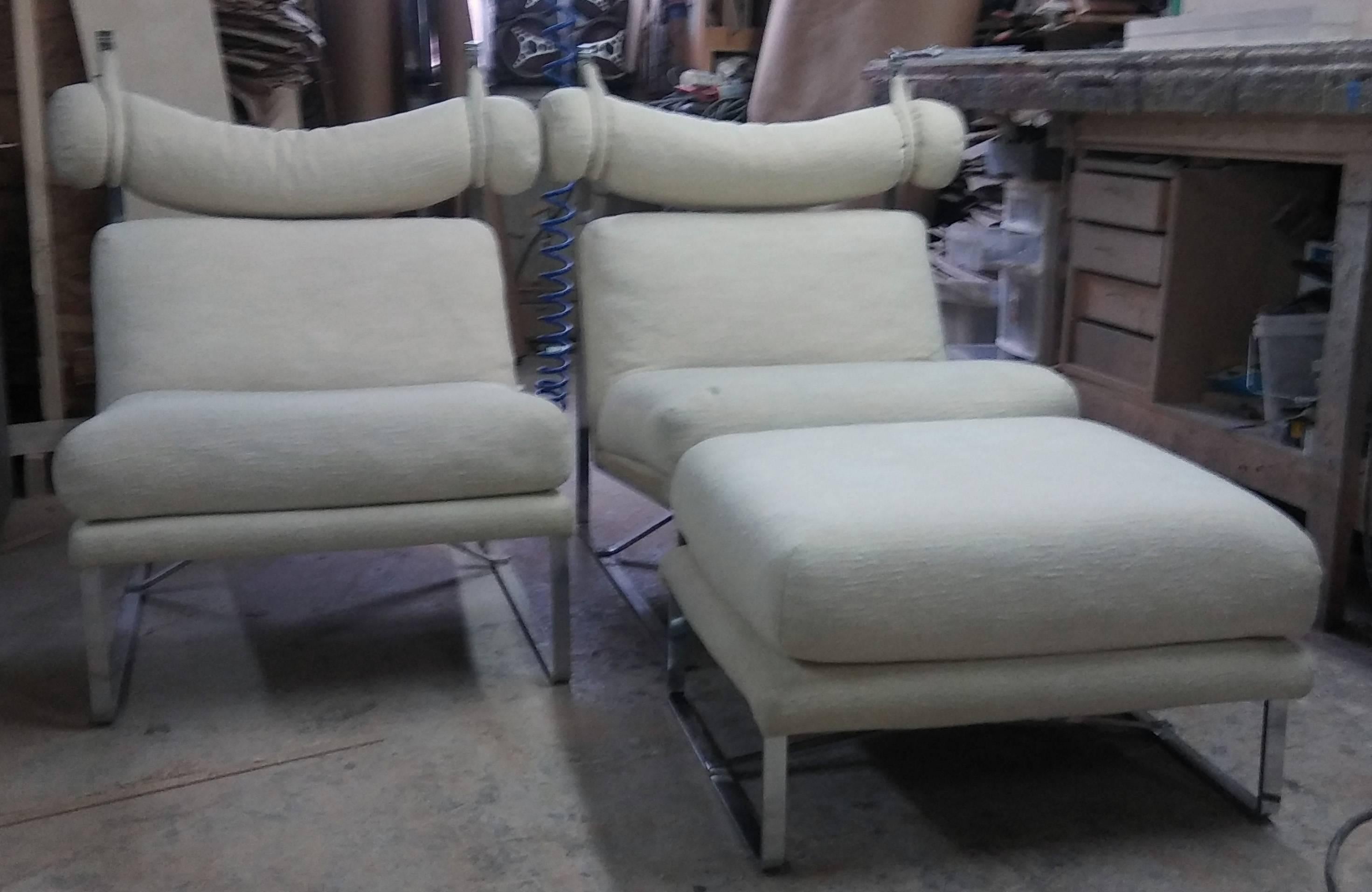 Unusual suite of luxurious Mid-Century Modern club chairs with matching ottoman. The bases are in chrome.