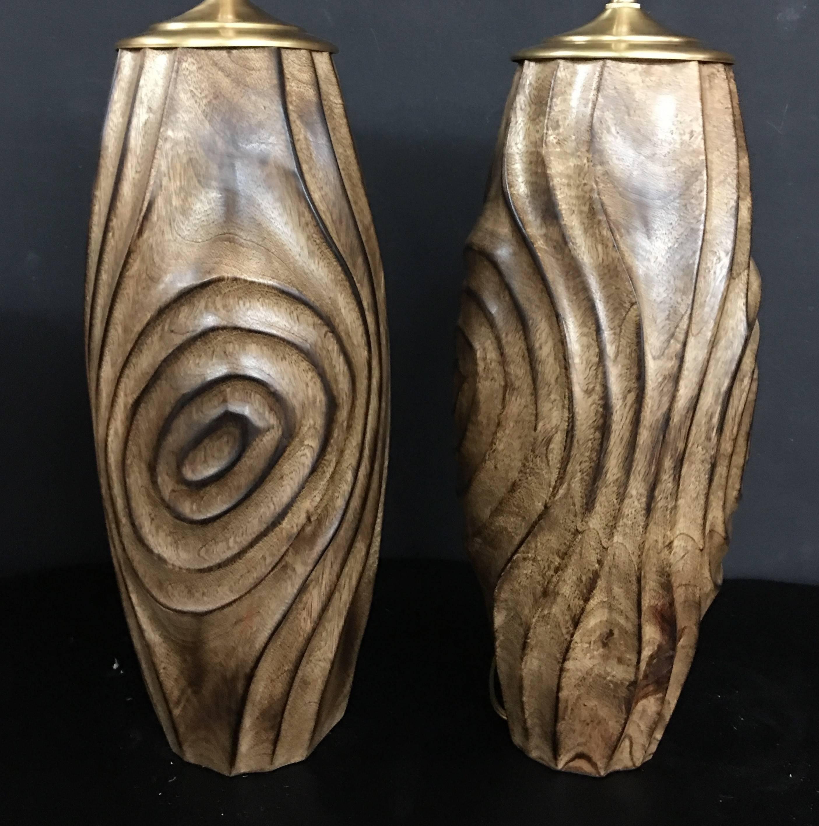 Unique pair of newly wired, hand-carved wood vessels with lamp application. The hardware is brushed brass and composes dual, individually controlled sockets. The vessel height is 16
