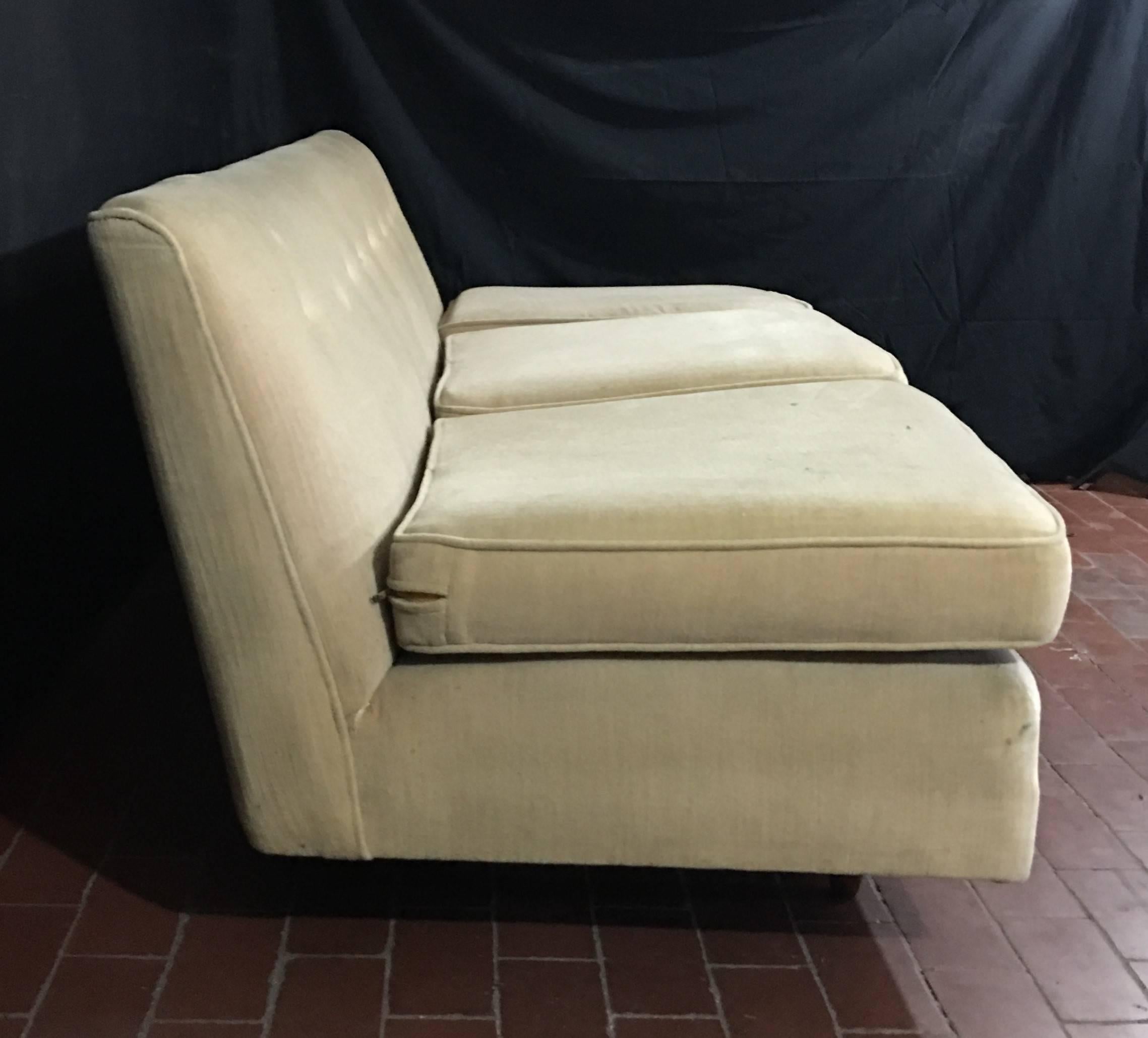 Vintage, midcentury armless sofa and chair. The frames are structurally sound but should be refurbished. Offered as is, it is priced at $2250, or, following full refurbishment and re-upholstery at $3500.00, COM: 22 yds The side chair is 34