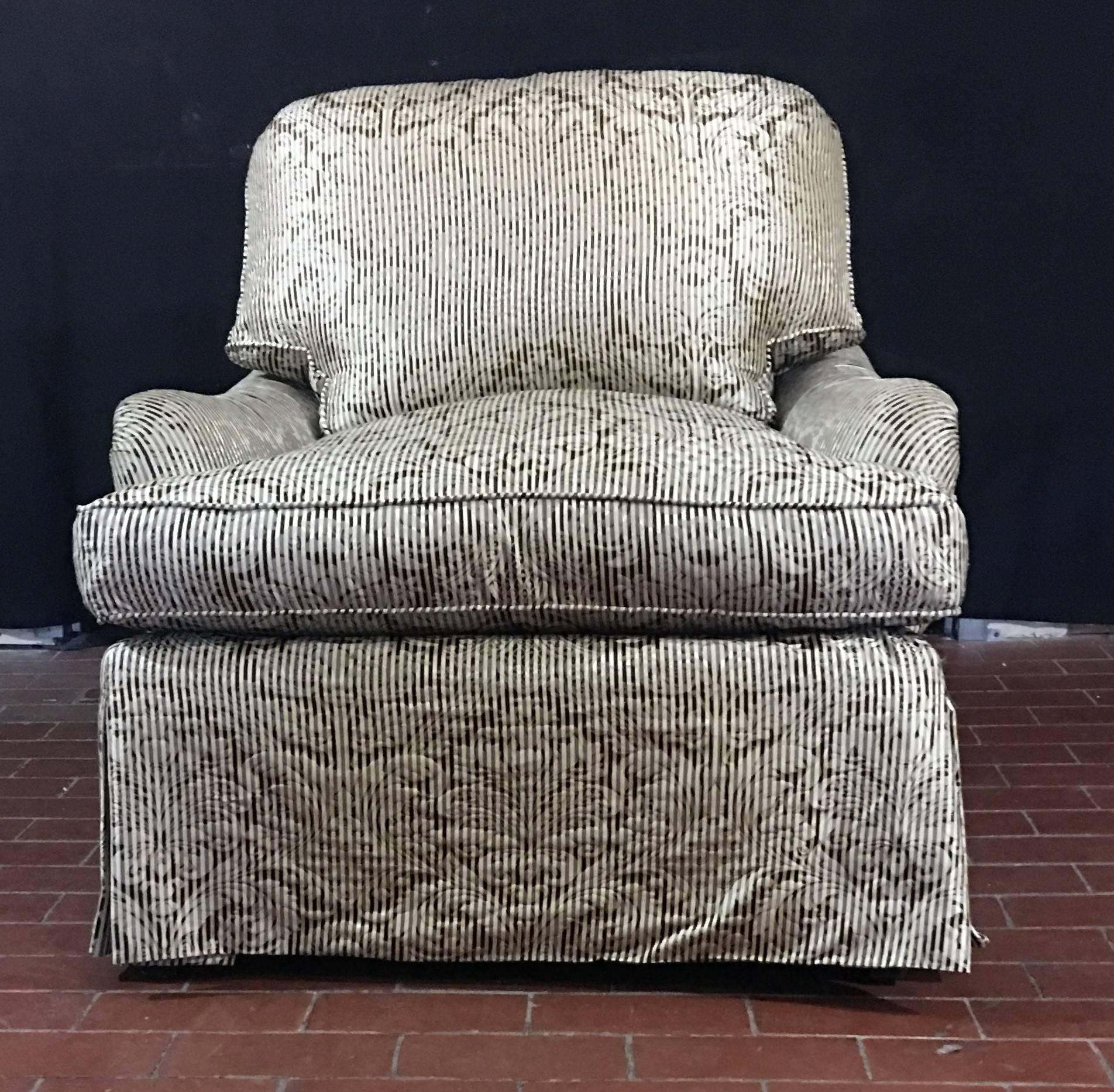 Elegant, luxurious pair of Bridgewater style club chairs. Made of the finest construction and composition, these chairs are made with a solid, hardwood frame and 8 way-hand tied spring construction. They are shown in a beautiful silver and charcoal