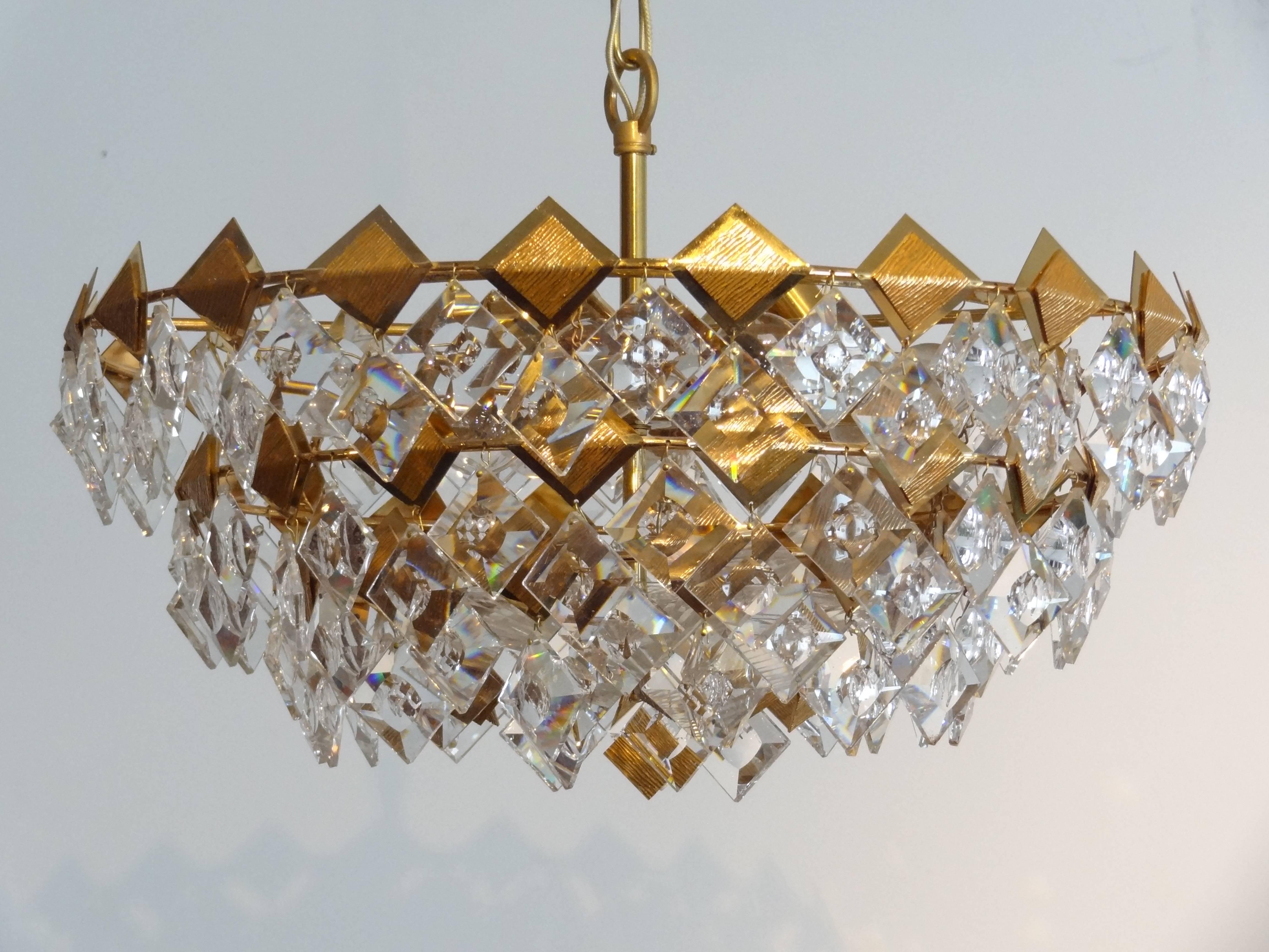 A gild brass chandelier with multiple faceted glass by Palwa.

German, Circa 1960's

 