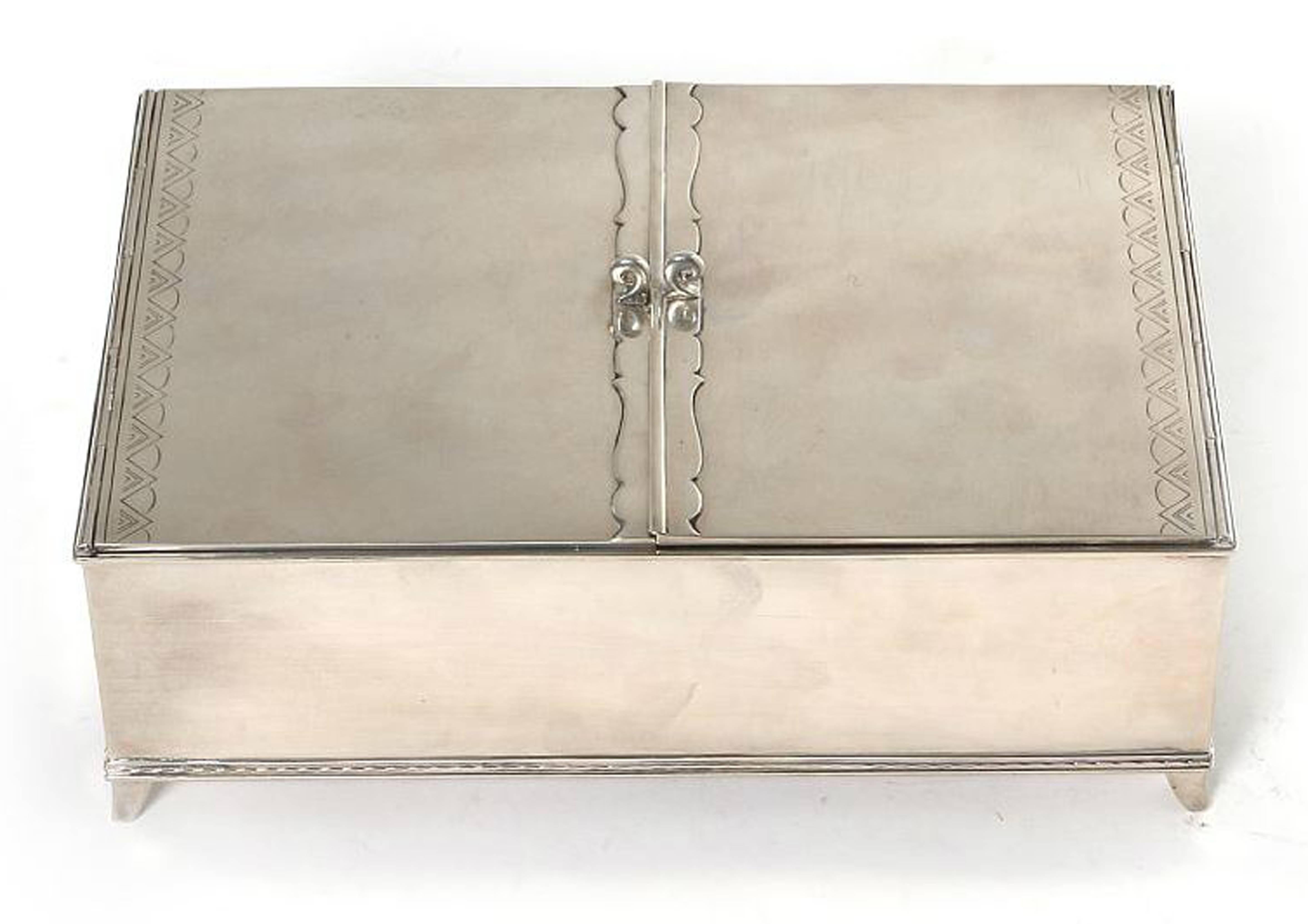 A silver box with two lids. 

Enchased with stylized ornamentation. 

Inside with two compartments covered by birch wood. 

Made and stamped by Just Andersen.

Denmark, Circa 1930's

In Stock.