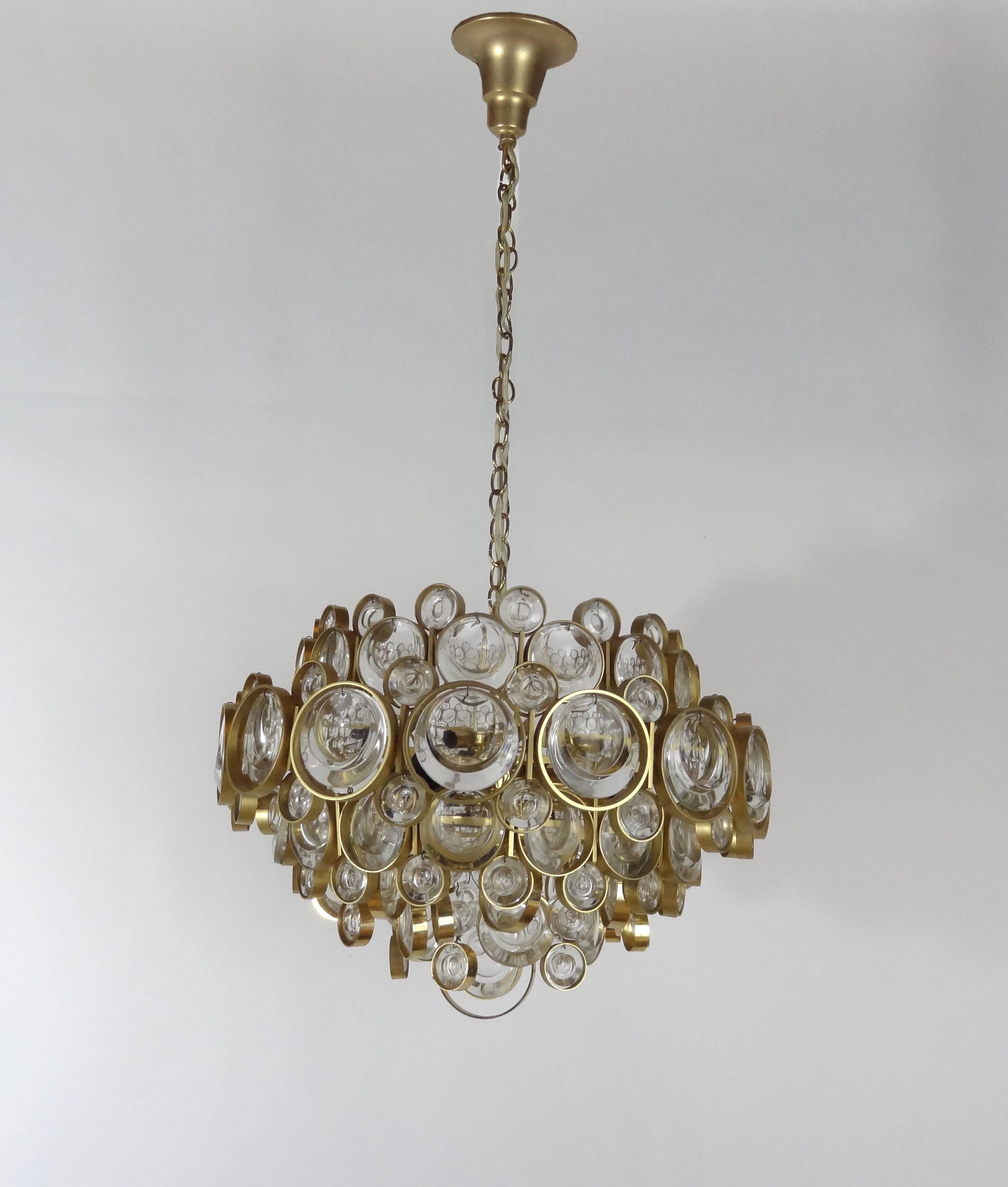 A gilt brass chandelier with multiple rings with glass by Palwa.

German, Circa 1960's
